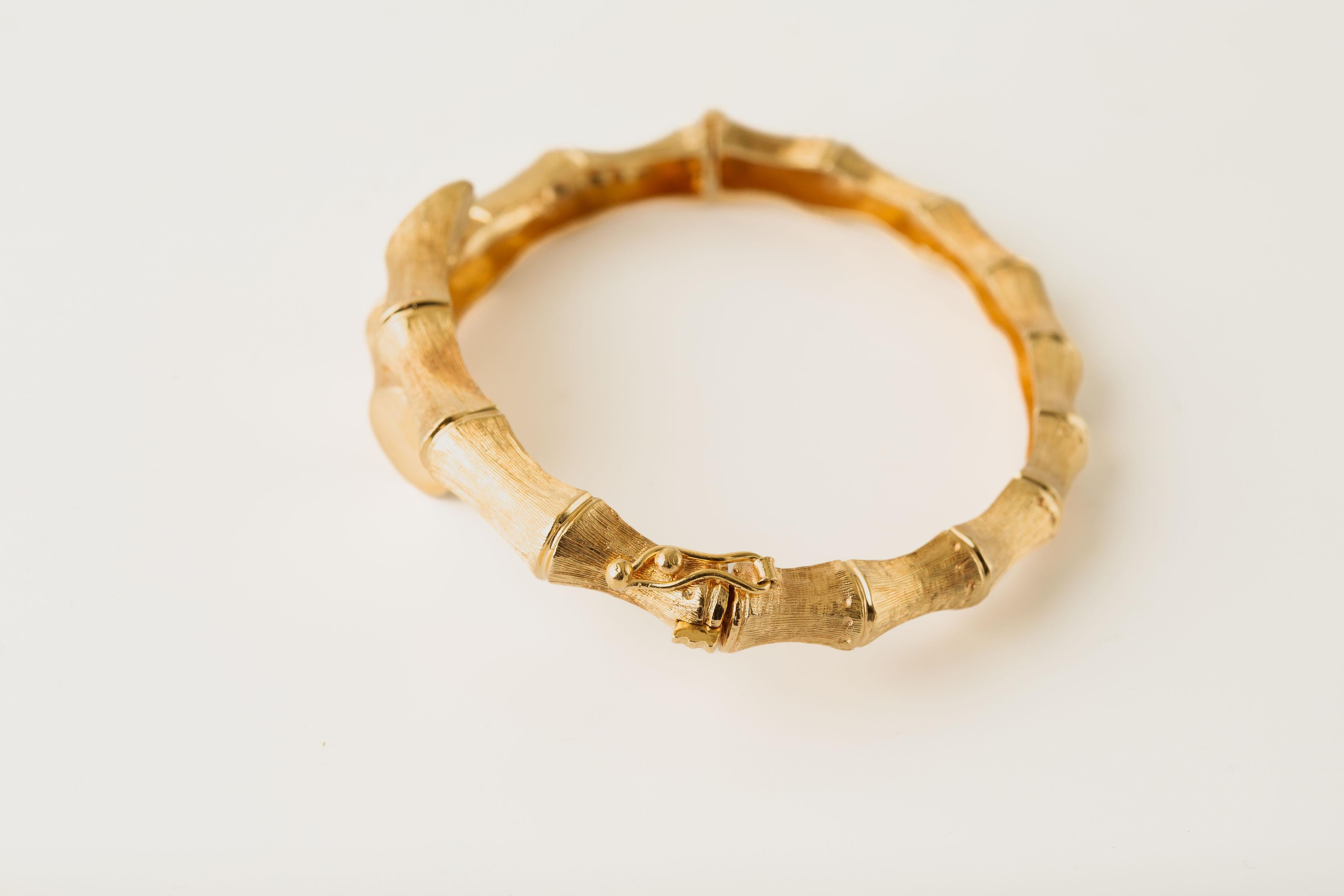 Material: 14k Yellow Gold
Weight: 22.6 grams
Size: 6.5 inches
Width: 17.1 mm (front of bracelet); 6.1 mm (back of the bracelet)

Florentine design 
This 14k yellow gold bangle features a beautifully textured and engraved surface with Florentine