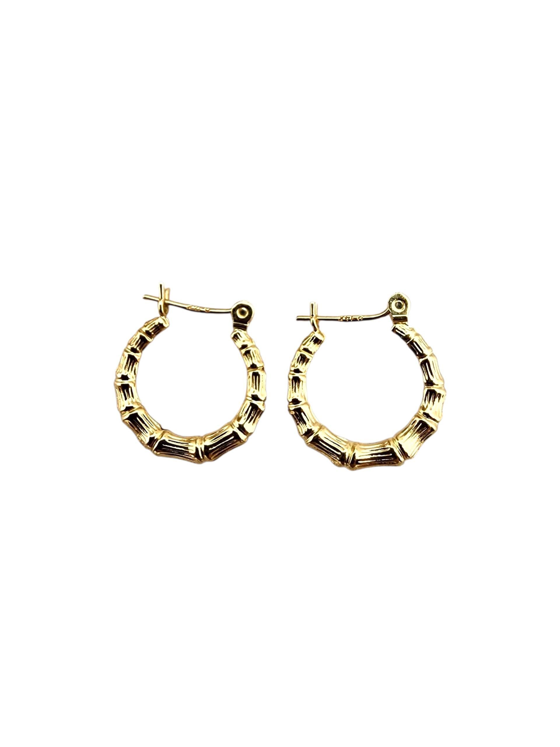 14K Yellow Gold Bamboo Style Hoop Earrings

14K yellow gold bamboo-style hoops featuring a textured, natural-inspired design for a chic and unique look.

Size: 15 mm x 15.8 mm 
Thickness: 3mm

Weight: 0.8 gr./ 0.5 dwt.

Stamped: ICM 14K

Very good