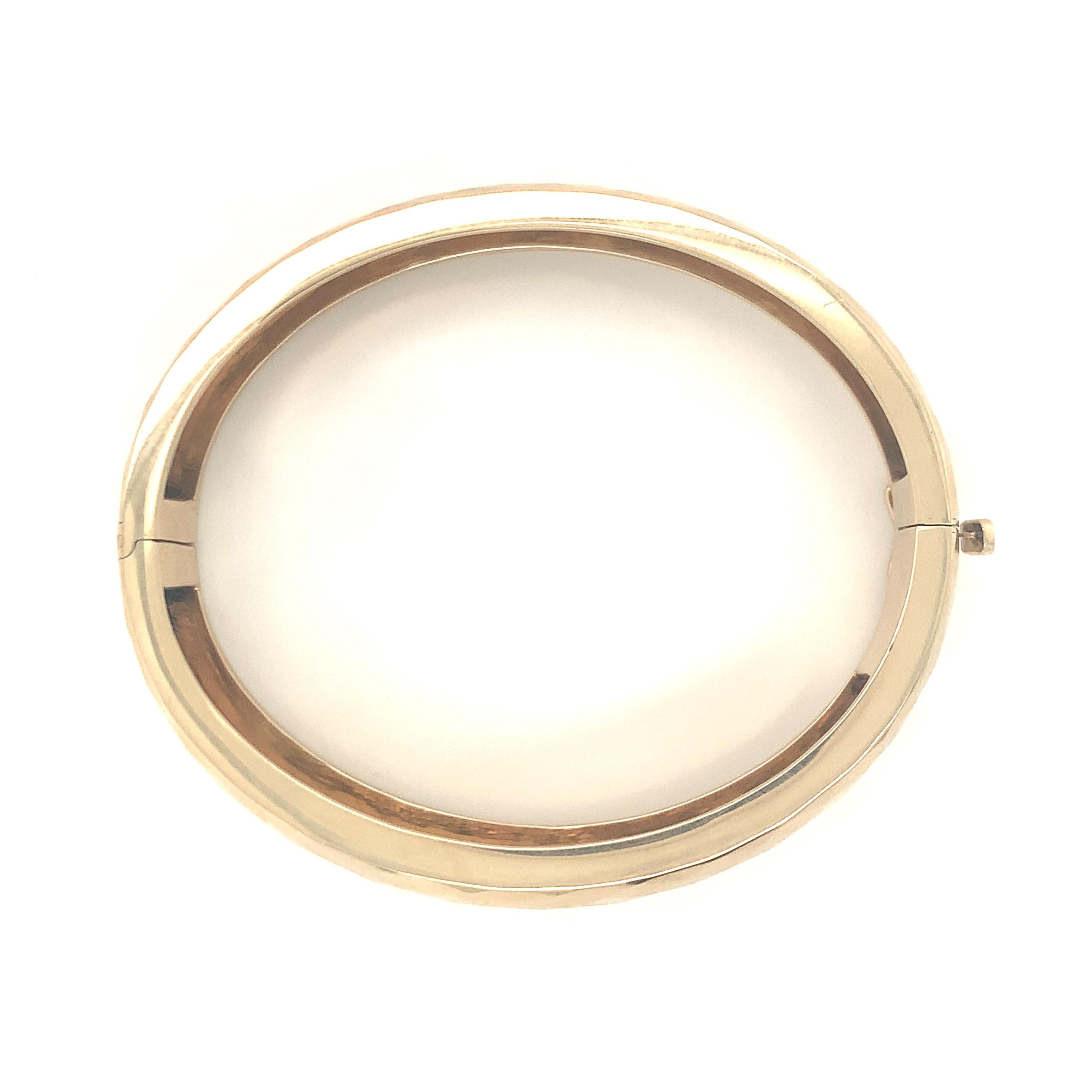 One 14K yellow gold bangle bracelet featuring a high polish, diamond-shaped surface style finish. Measuring 0.5 inches wide. Circa 1970s.

Sleek, glowing, scintillating.

Additional information:
Metal: 14K yellow gold
Circa: 1970s
Stamp/Hallmark: