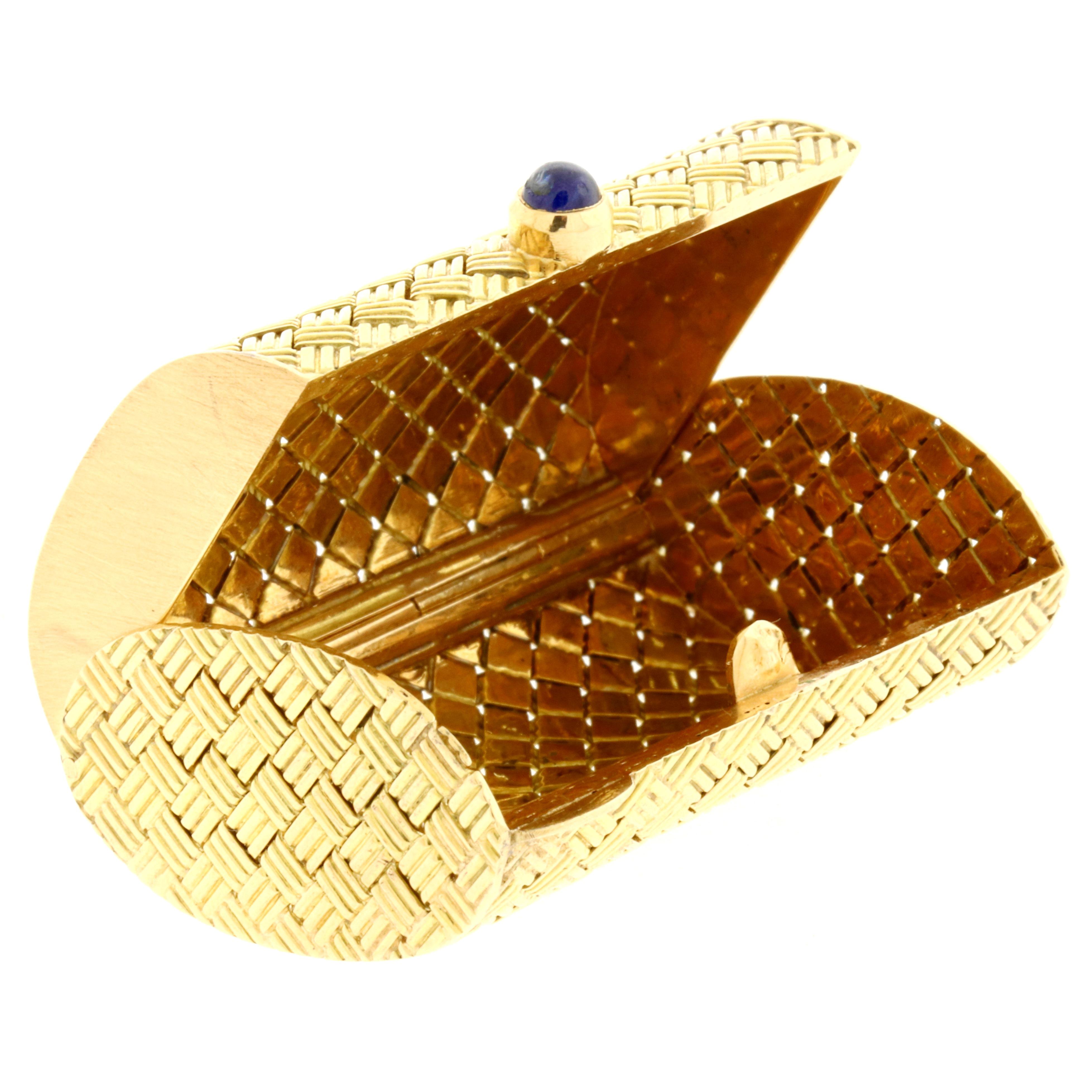 This amazing 14K yellow gold and sapphire cabochon pill box features an elegant basket weave design and was crafted with impeccable quality. Beautiful workmanship, flawless functionality and ever so eye catching; this iconic design was typically