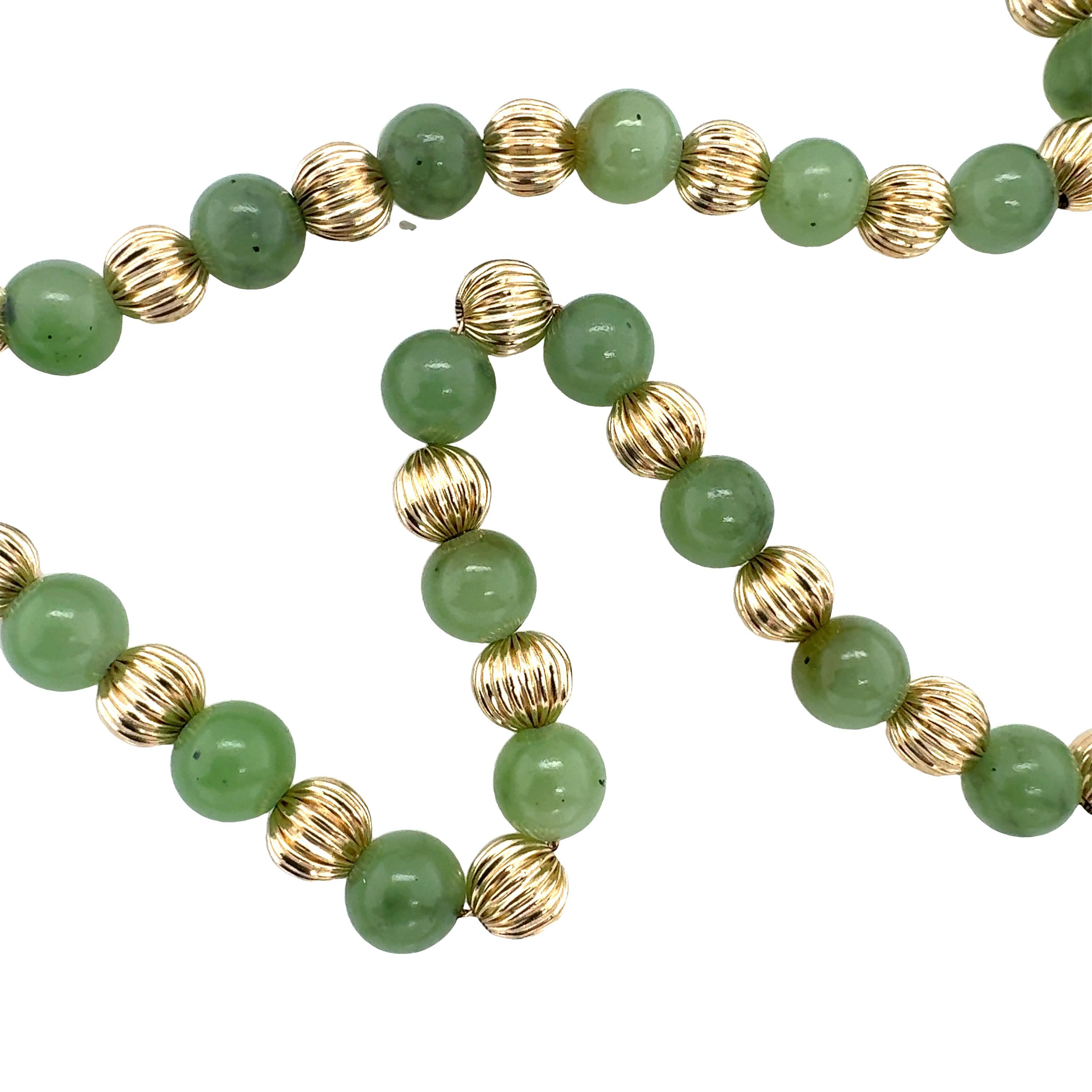 One 14K yellow gold bead and green jade bead necklace with alternating, interspaced beads.  With 57 ribbed gold beads measuring 7 millimeters in diameter on average and 57 green jade beads measuring 8 millimeters in diameter on average.

Metal: 14K