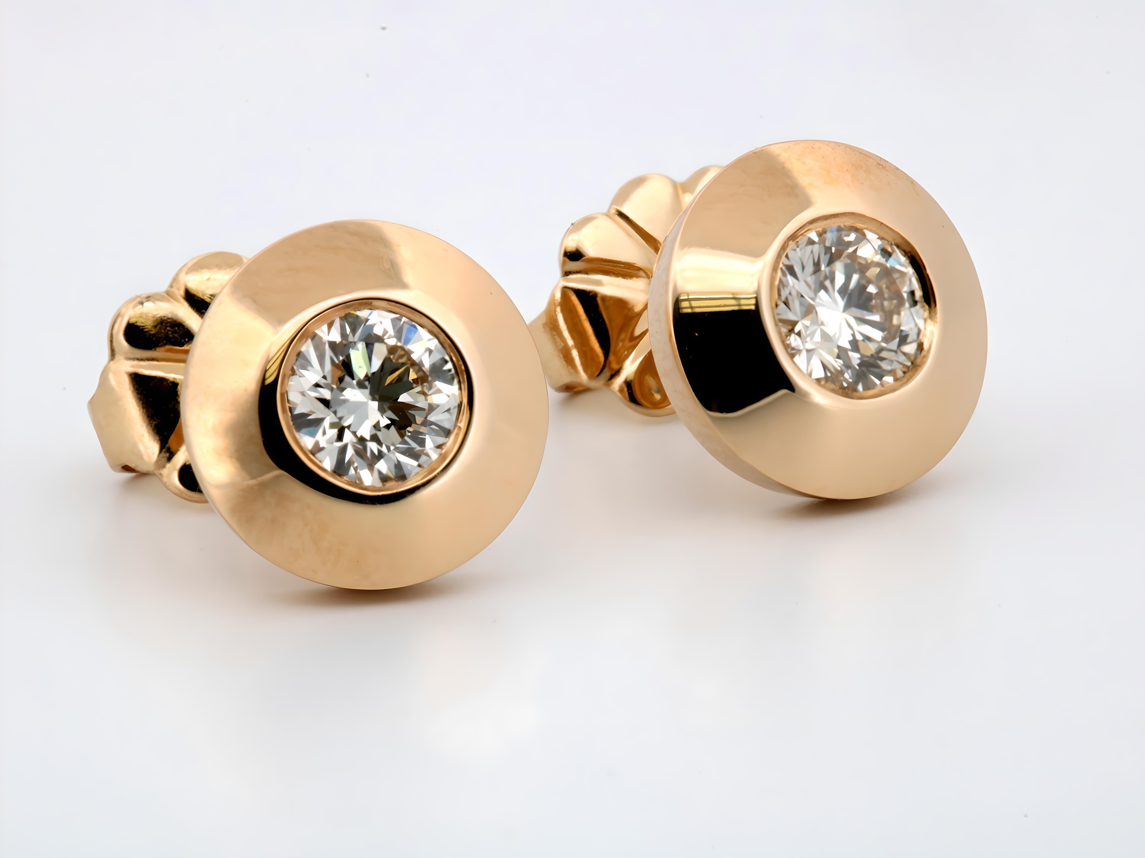 These stunning earrings are crafted from luxurious 14K yellow gold, exuding a timeless elegance that is both modern and classic. Each earring is set with a brilliant round-cut natural diamond, totaling 0.40 carats across the pair. The diamonds are