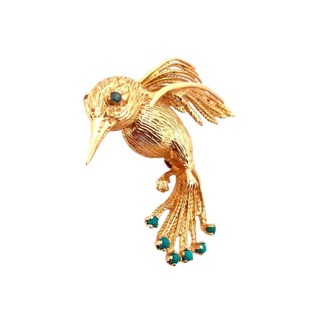 14K Yellow Gold Bird Brooch, a delightful piece that effortlessly combines nature's beauty and elegance. 
Crafted with care and weighing 6.6 grams, this brooch features six vibrant turquoise stones and captivating blue diamond eyes, adding a touch