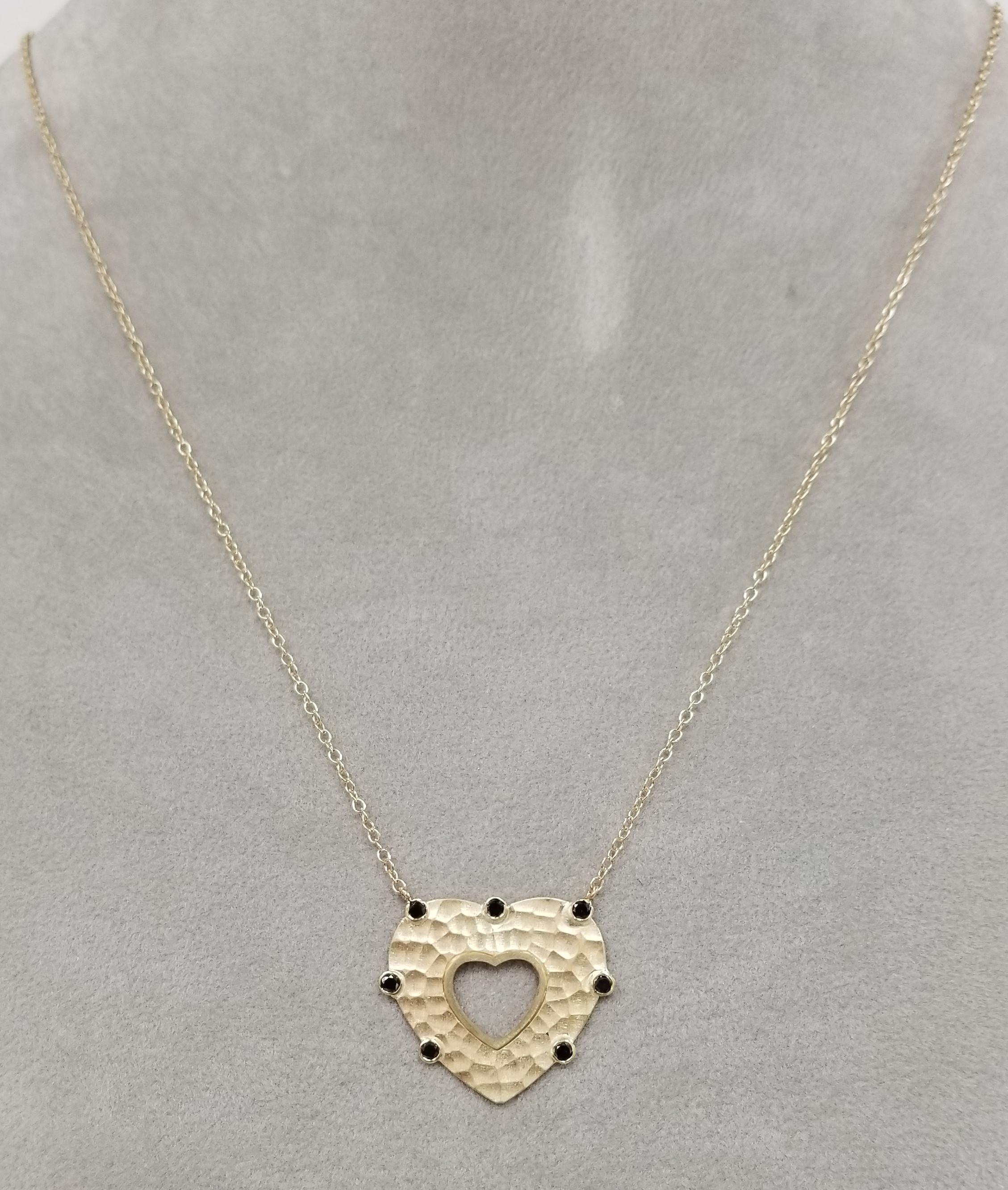 14k yellow gold  black diamond hammered heart necklace, containing 7 bezel set black round full cut diamonds weighing .28pts. on a 18 inch chain.