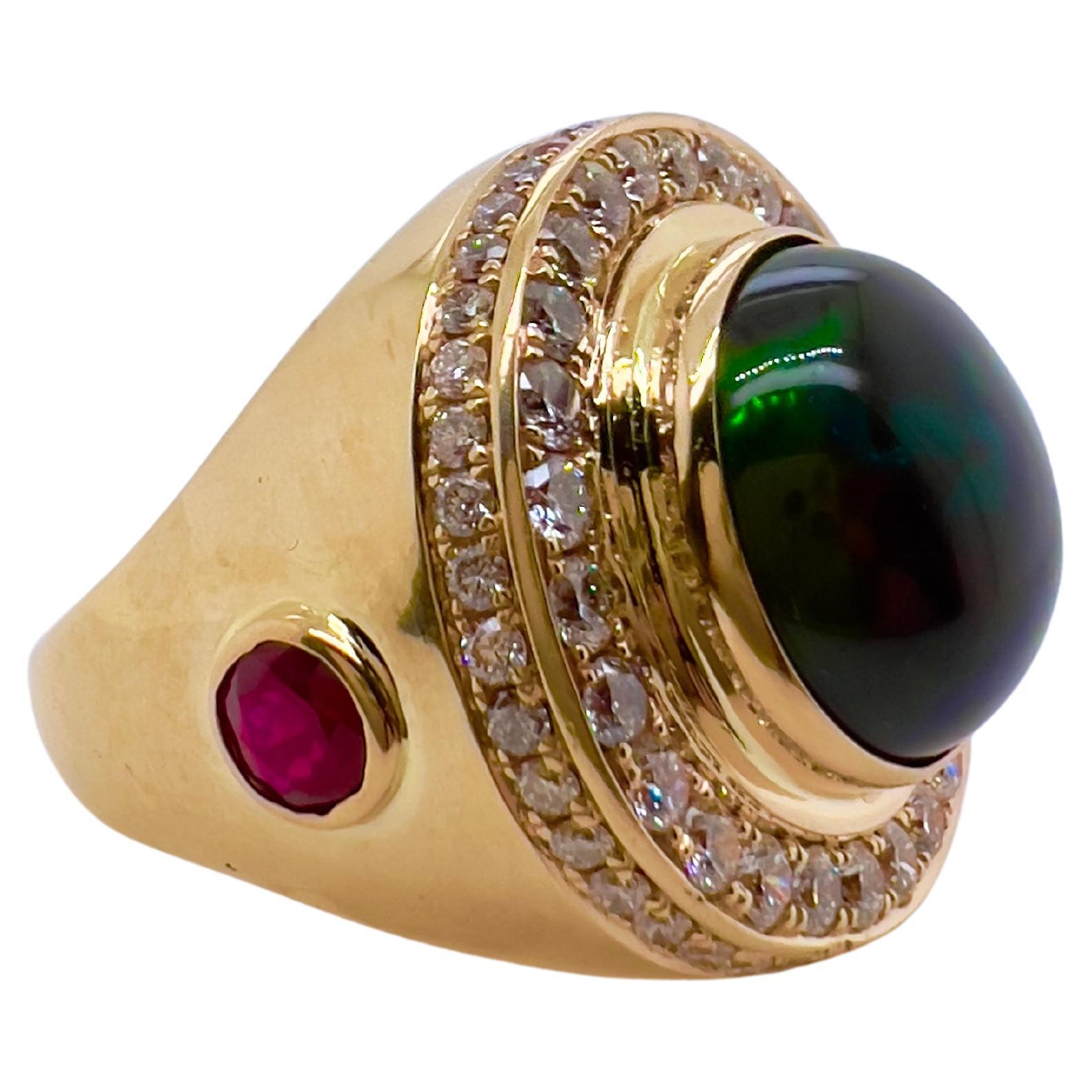 This amazing Black Ethiopian Opal has an amazing colors ranging from green to red to yellow.  The handmade setting is so unique with the two bezel set rubies on the sides that complement the round brilliant diamonds surrounding the opal.  The under