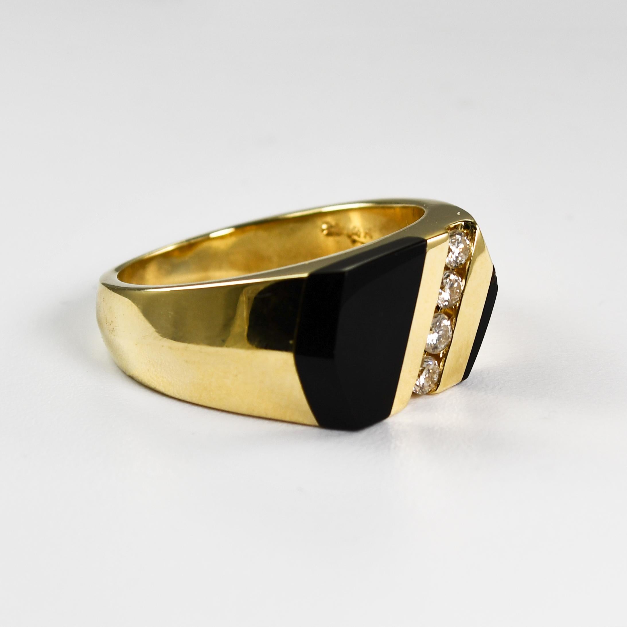 Men's black onyx and diamond ring in 14k setting.
Stamped 14k and weighs 14.1 grams gross weight.
The diamonds are round brilliant cuts, .20 total carats, J to K color, Si clarity.
The top of the ring measures 10.5mm wide.
Ring size is 10 and can be