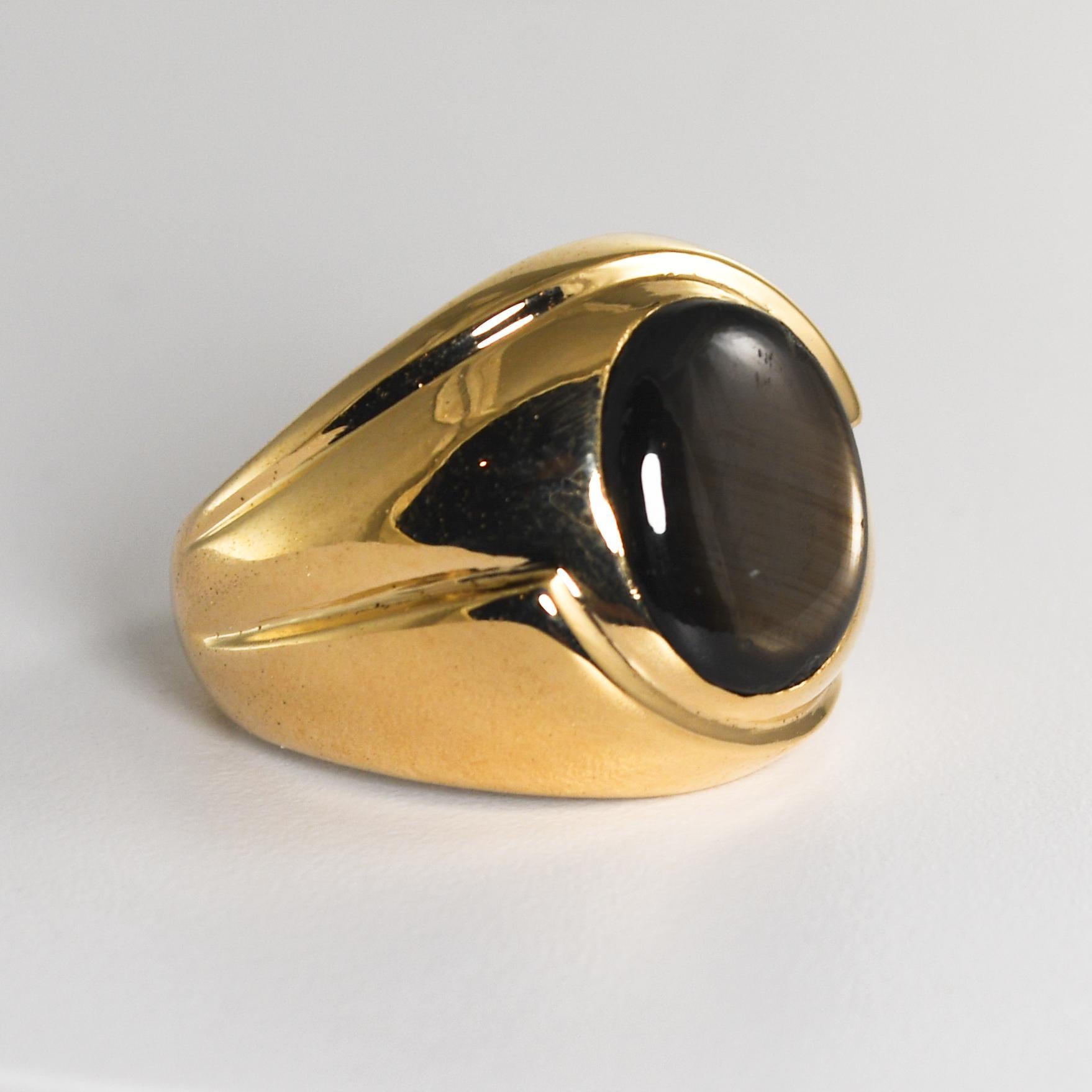 Unisex ring.
14k yellow gold and black cabochon star sapphire.
The ring tests 59% gold using an XRF metals analyzer.
The gross ring weight is 12.3 grams.
The black sapphire is oval and measures 12mm by 9mm.
The star can be seen under a light or