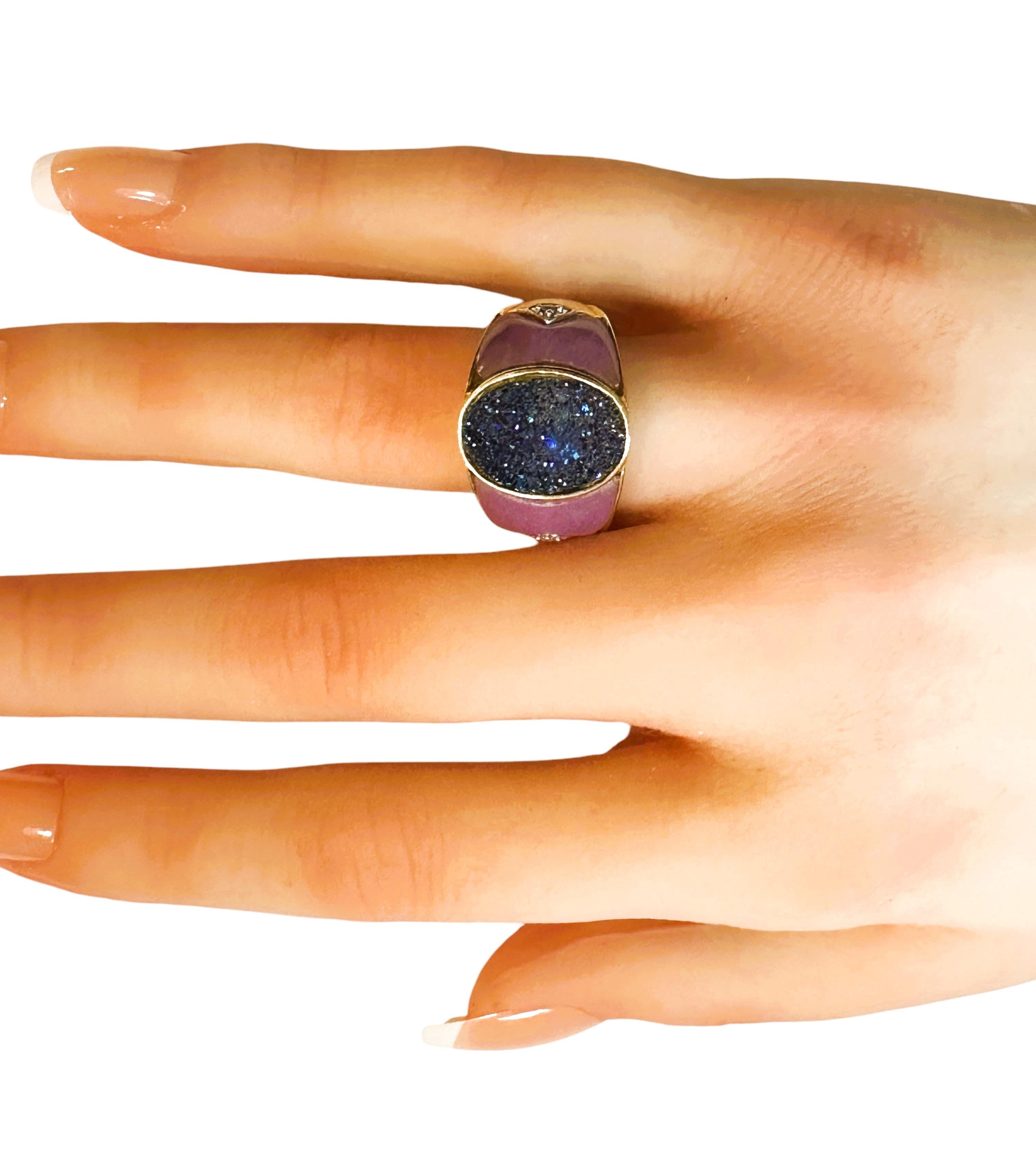 This ring is just gorgeous!  It is a one of a kind design.   It has beautiful 14 X 10 mm blue druzy center stone that is surrounded by a 14k yellow gold band.  The sides are made of purple jade over 14k gold.  It also has a 2 mm brilliant cut