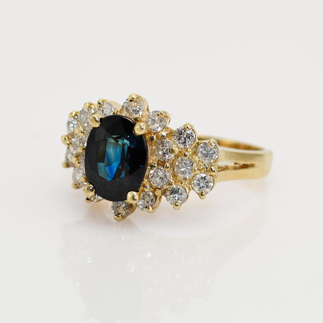 Ladies blue sapphire and diamond ring in 14k yellow gold setting.

Stamped 14k and weighs 5.2 grams gross weight.

The genuine sapphire is an oval shape, dark blue color, 2.00 carats.

The diamonds on the sides are round brilliant cuts, .70 total