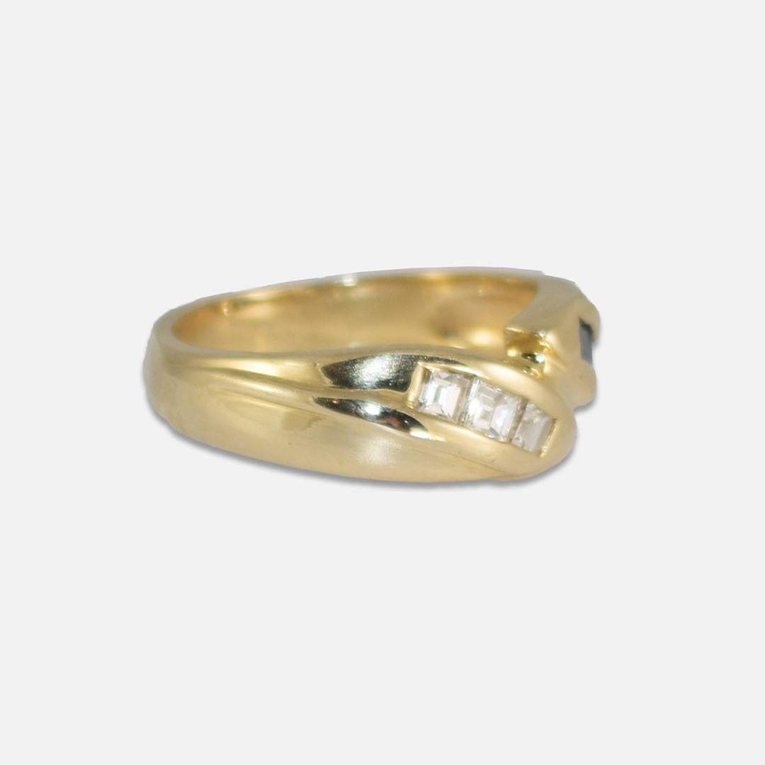 14k yellow gold ring with diamonds and blue accent gemstones.
Stamped 14k and weighs 5.4 grams.
The diamonds are emerald cuts, g,h, i color range, Vs clarity.
The blue stones look like blue spinel but are too small to authenticate.
The top of the