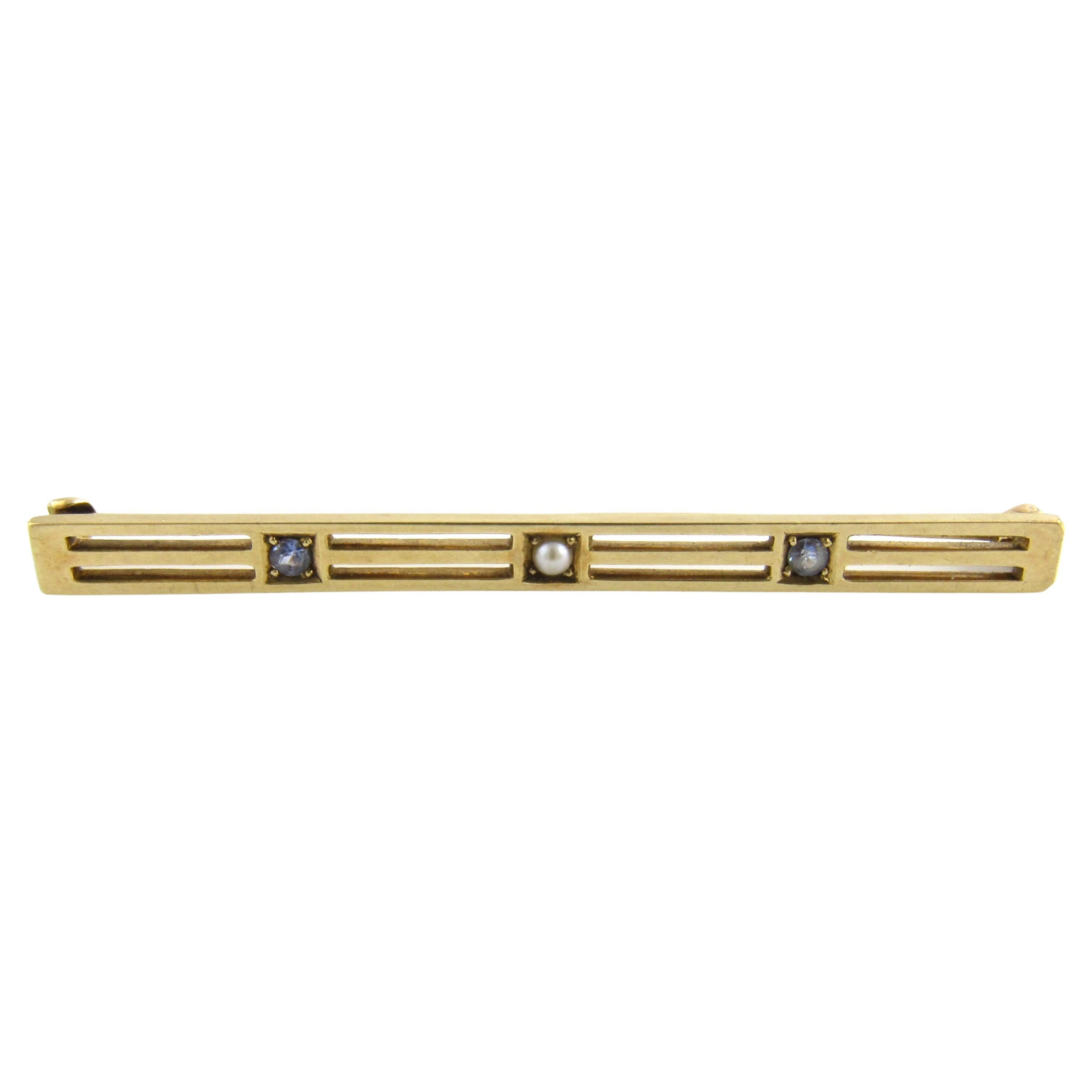 Broche en or jaune 14 carats avec topaze bleue et perle