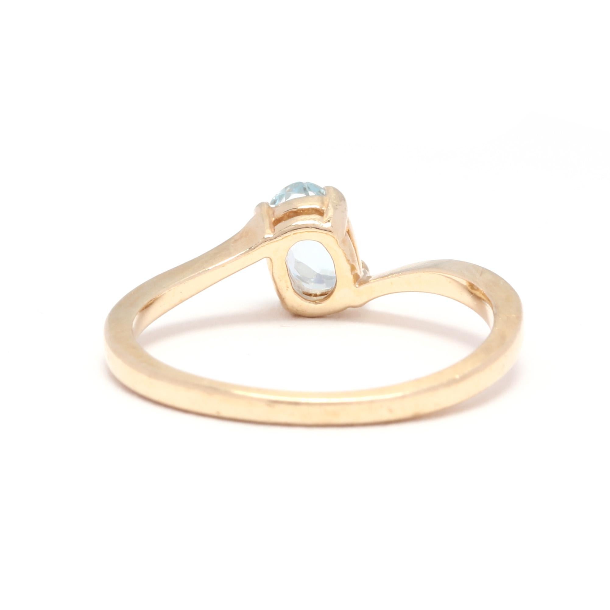 Oval Cut 14 Karat Yellow Gold and Blue Topaz Bypass Solitaire Ring
