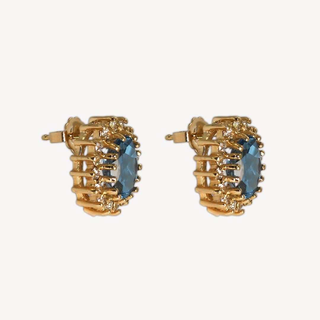 Ladies' blue topaz and diamond earrings in 14k yellow gold settings.
Stamped 14k and weighs 5.7 grams gross weight.
The oval shape topaz has a nice dark blue, 4.00 total carats.
On the sides are round brilliant cuts, .60 total carats, i to j color,