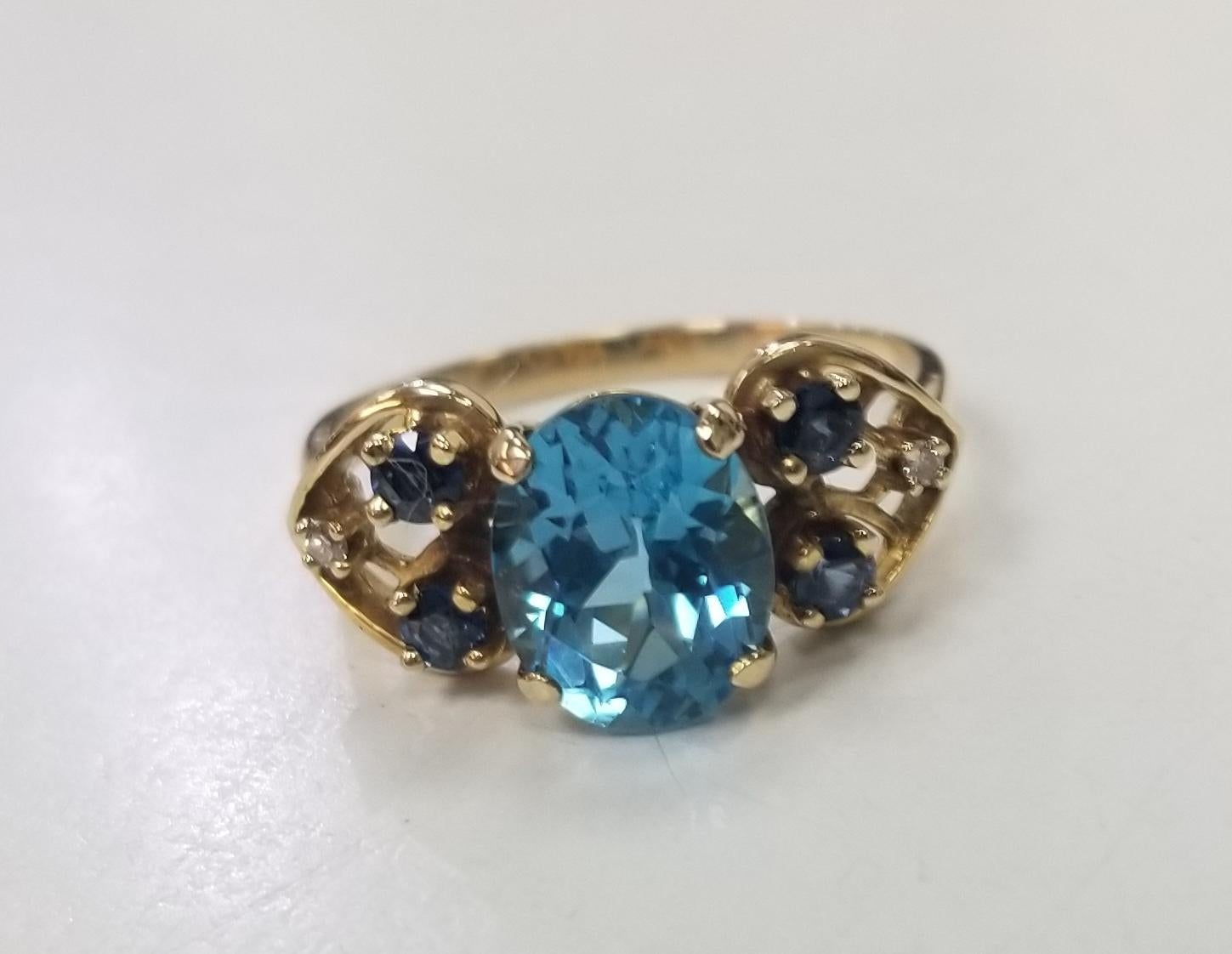 Contemporary 14k yellow gold Blue Topaz, Sapphire and Diamond ring and earring set For Sale