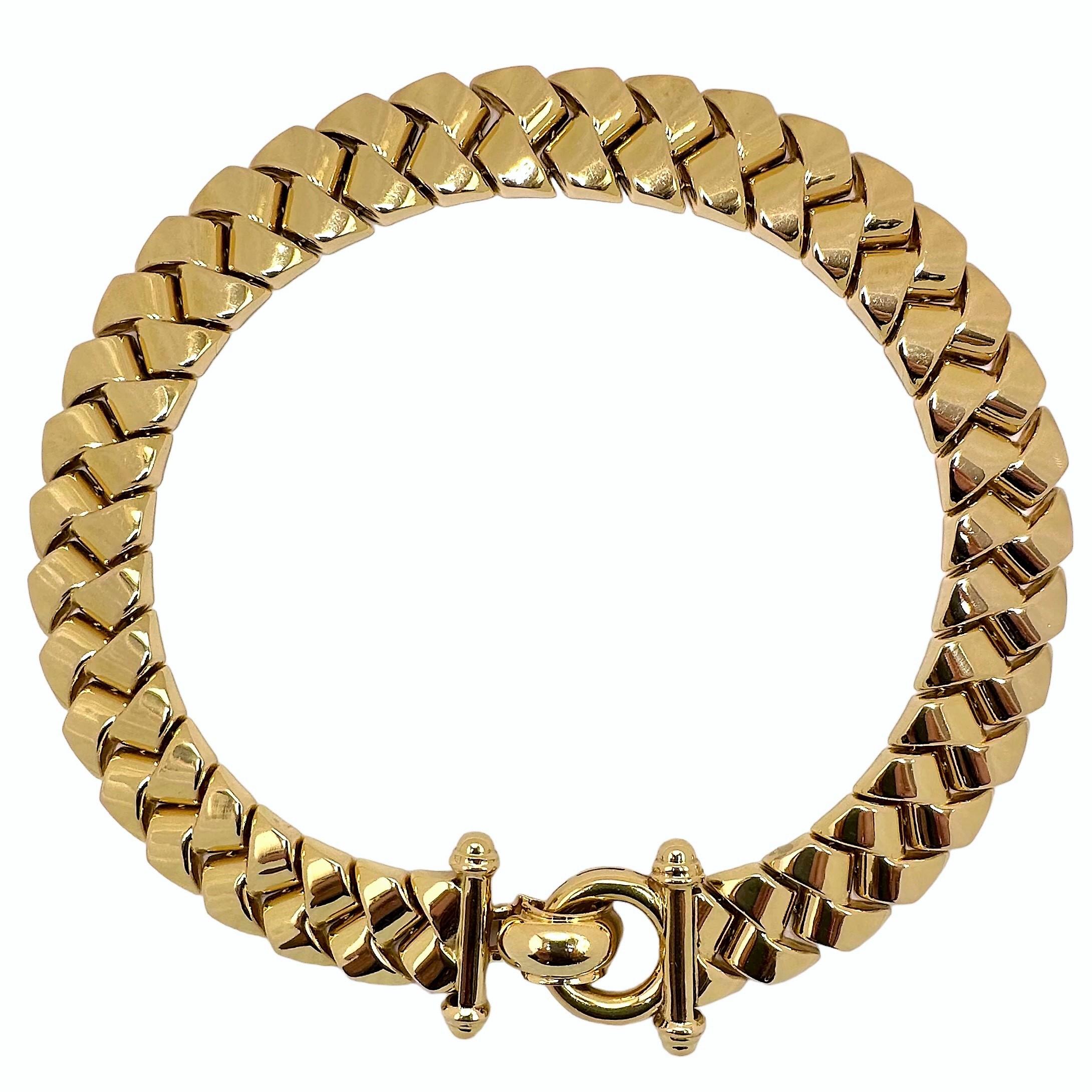 This late-20th Century heavy gauge hollow Italian 14K yellow gold braided link choker necklace is very substantial in appearance and is extremely comfortable to wear. Measures 15 inches long by 11/16 inch wide. The dramatic ring and flip clasp can