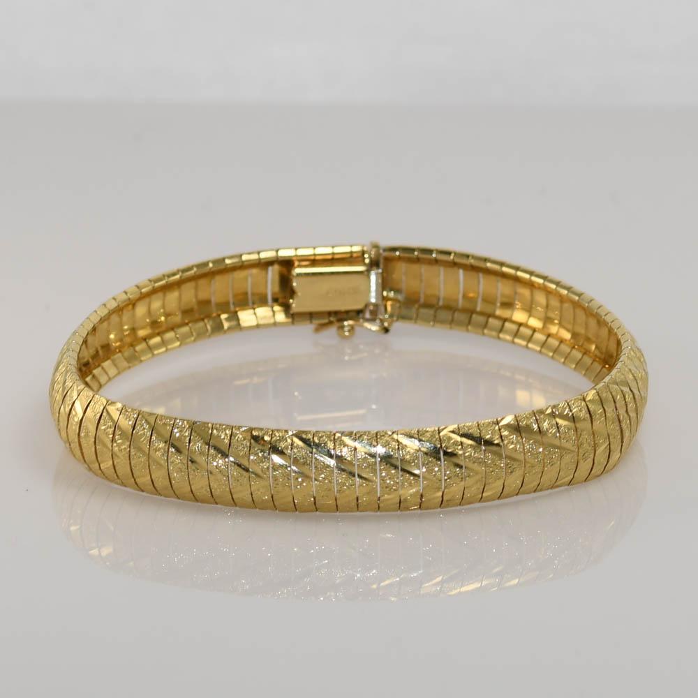 One 14kt yellow gold 9.3mm wide flexible bracelet. 
This bracelet is stamped 14kt ITALY.
Very well made. 
This is a everyday wear bracelet. 
There are 2 slight kinks in the bracelet. 
There is only one kink you can see from the top.
You can see both