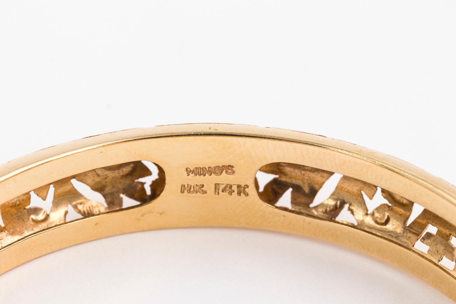 14K yellow gold bracelet made by Ming's of Honolulu. It has the signature Leaf Scroll and Longevity pierced gold work and is signed Ming's H.K. 14k. Inside diameter of the bracelet is 2 3/8 inches. 12 mm tall and 5 mm thick - with a nice 3-D