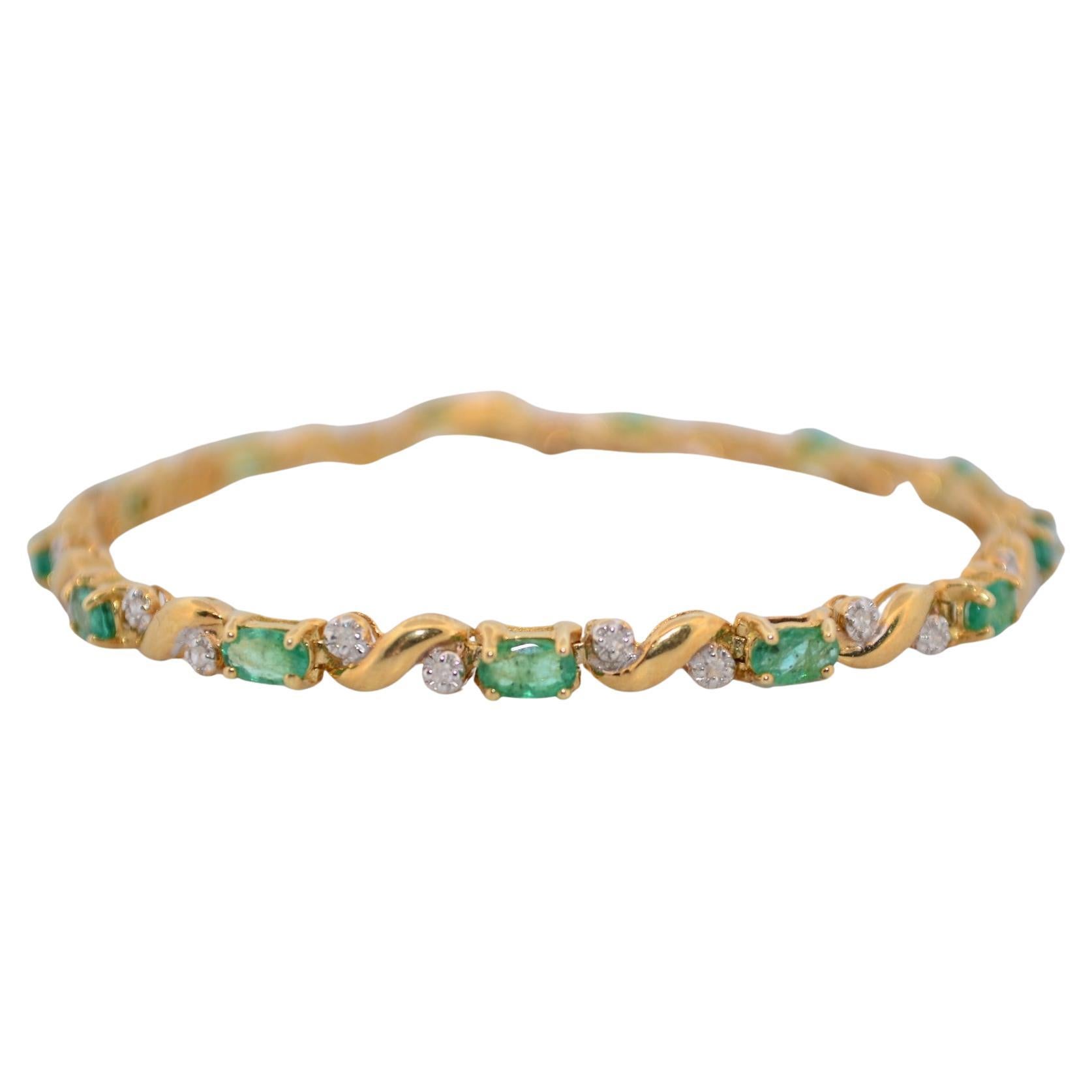 14K Yellow gold bracelet with diamonds and emeralds