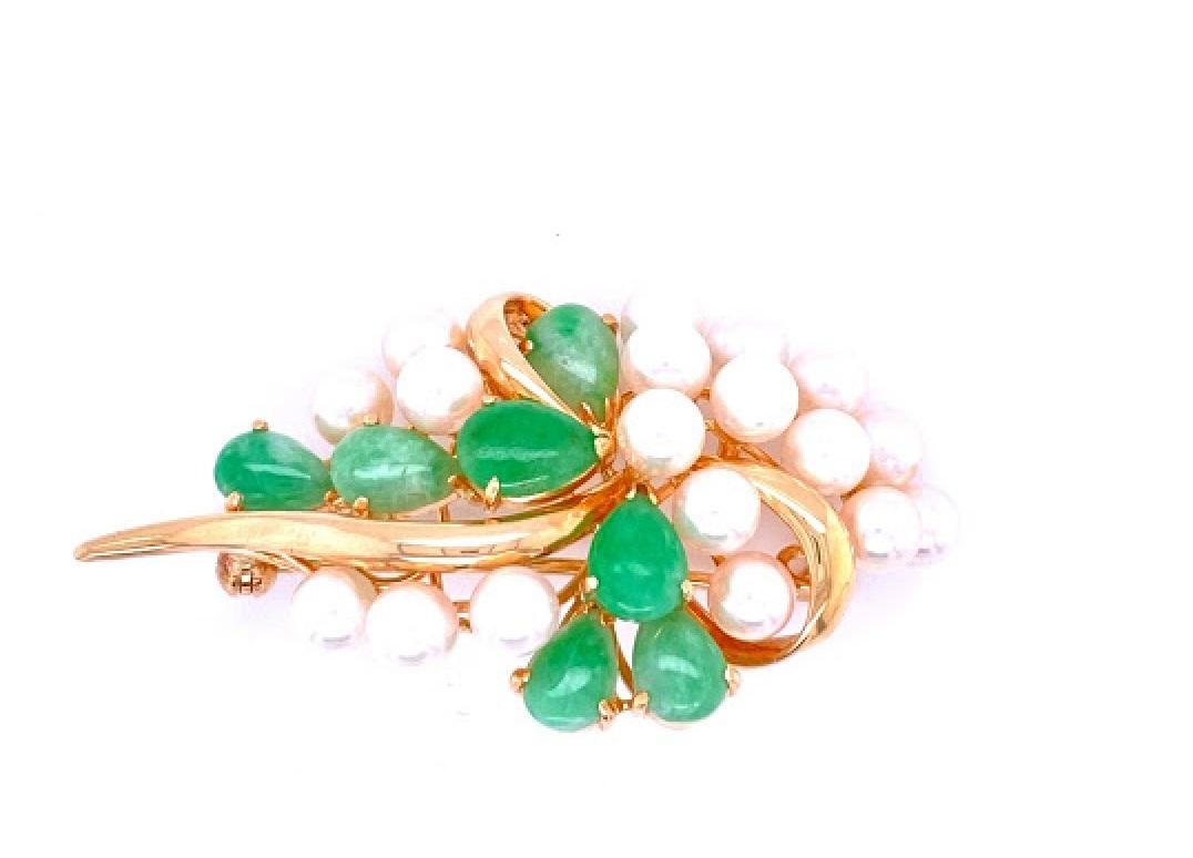 14 karat yellow gold (stamped 14K) broach with 18 4 - 4.5 mm cultured akoya pearls, and 7 7.5 x 5.7 mm jadeite. The broach is 2’’ long and just over an inch wide. 