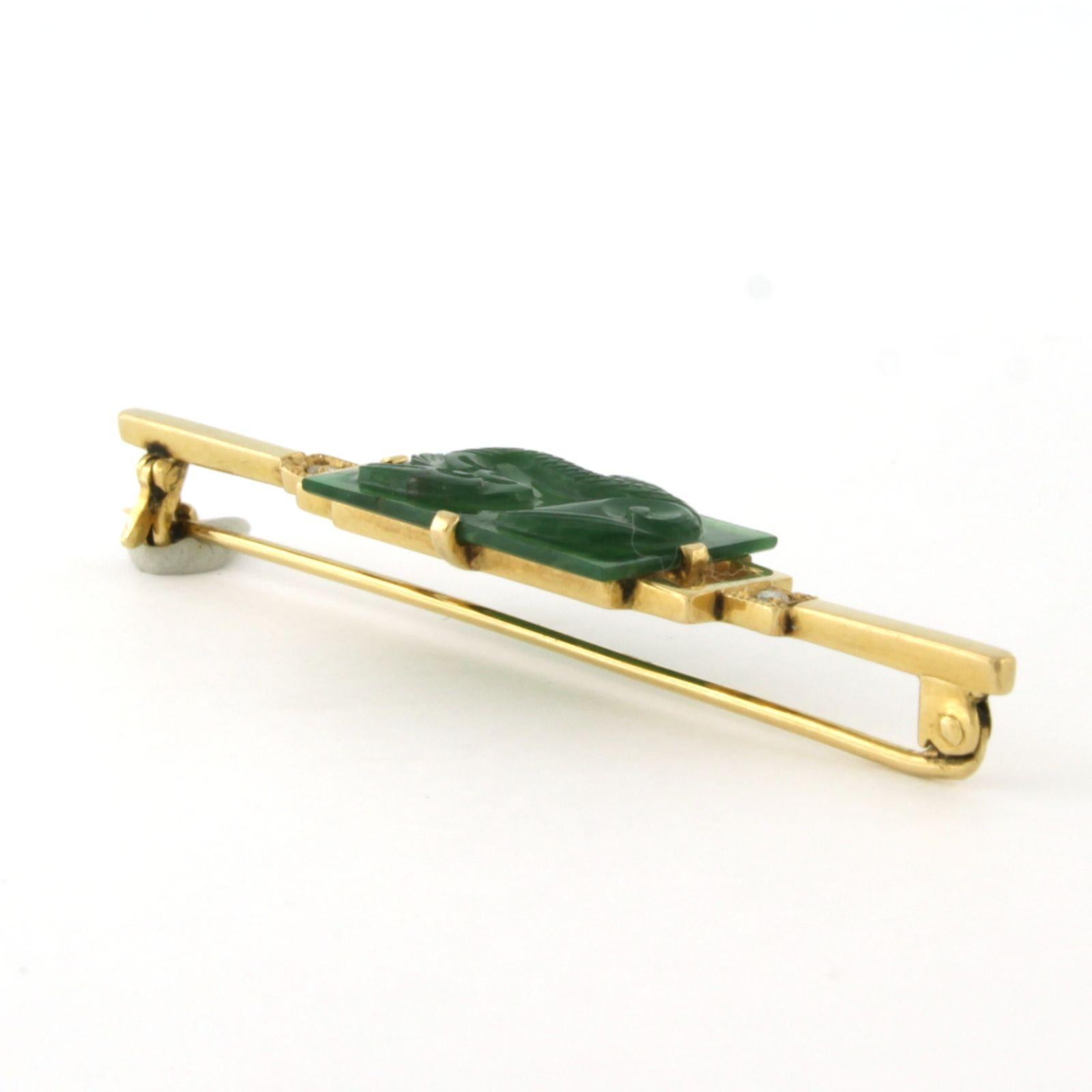 14k yellow gold brooch set with a jade and single cut diamonds up to 0.03ct - G/H - SI

detailed description:

the size of the brooch is 1.2 cm by 5.5 cm wide

weight 5.0 grams

set with

- 16 x 1.9 cm x 1.1 cm square with an engraving of a Chinese