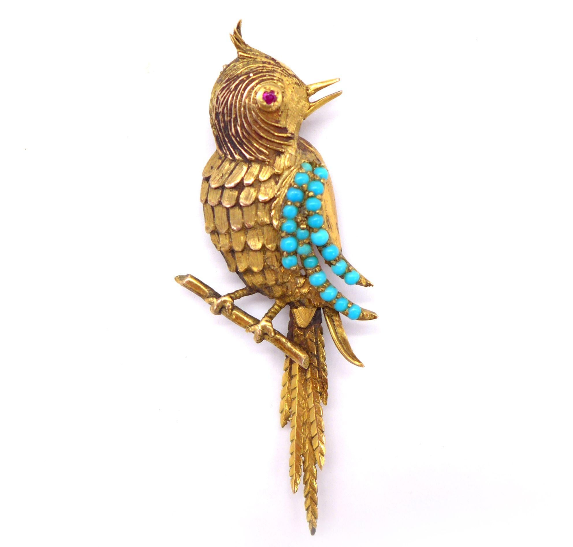 

Gold brooch representing a titmouse on its branch decorated with a ruby as an eye and turquoise cabochon on its feathers. Dimensions : 7.5 x 2.9 cm. Gross weight : 7.27 gr. A yellow gold, turquoise and ruby brooch. 