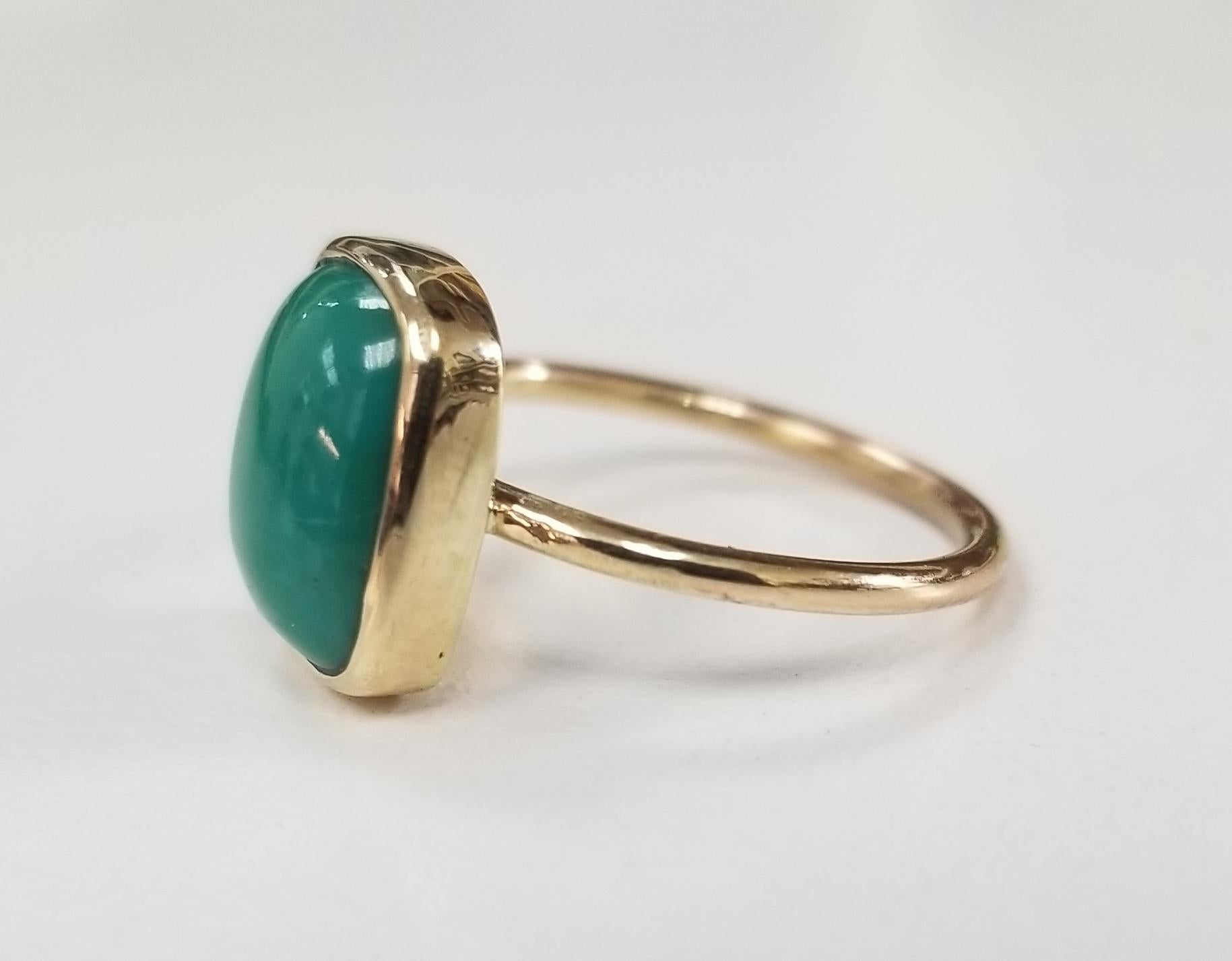 14k yellow gold cabochon cut turquoise ring, containing 1 round cabochon cut turquoise, ring is a size 6 and can be sized to fit.