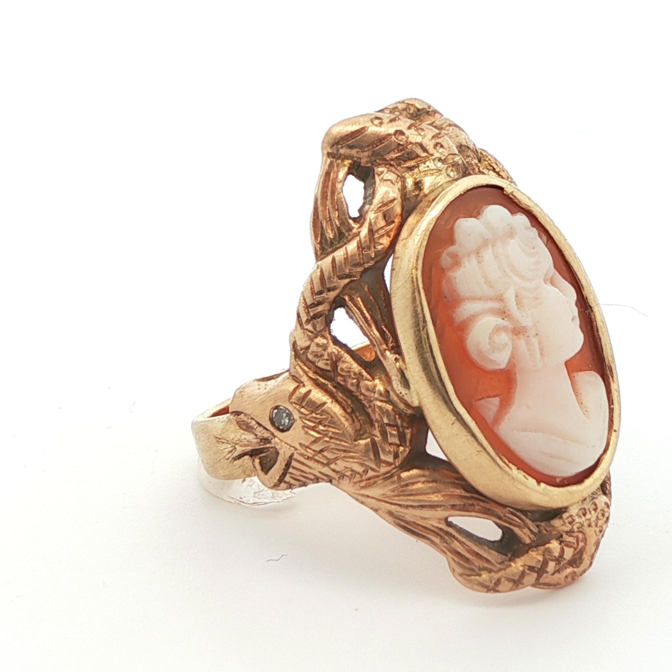 This refined cameo ring from the 1890 Edwardian period features a detailed snake crafted in 14k yellow gold wrapped around the cameo shell. The coiled snake enhances the overall design and theme of the ring beyond the ordinary. When taking a closer