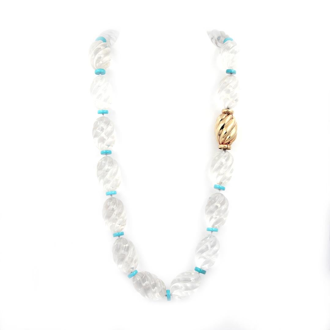 This bold necklace features 17 diagonally carved clear crystal beads spaced with 16 flat turquoise rondels. One large bead is crafted from 14 karat yellow gold with a polished finish. The necklace measures 27 inches long.
-	14k Yellow Gold
-	Clear