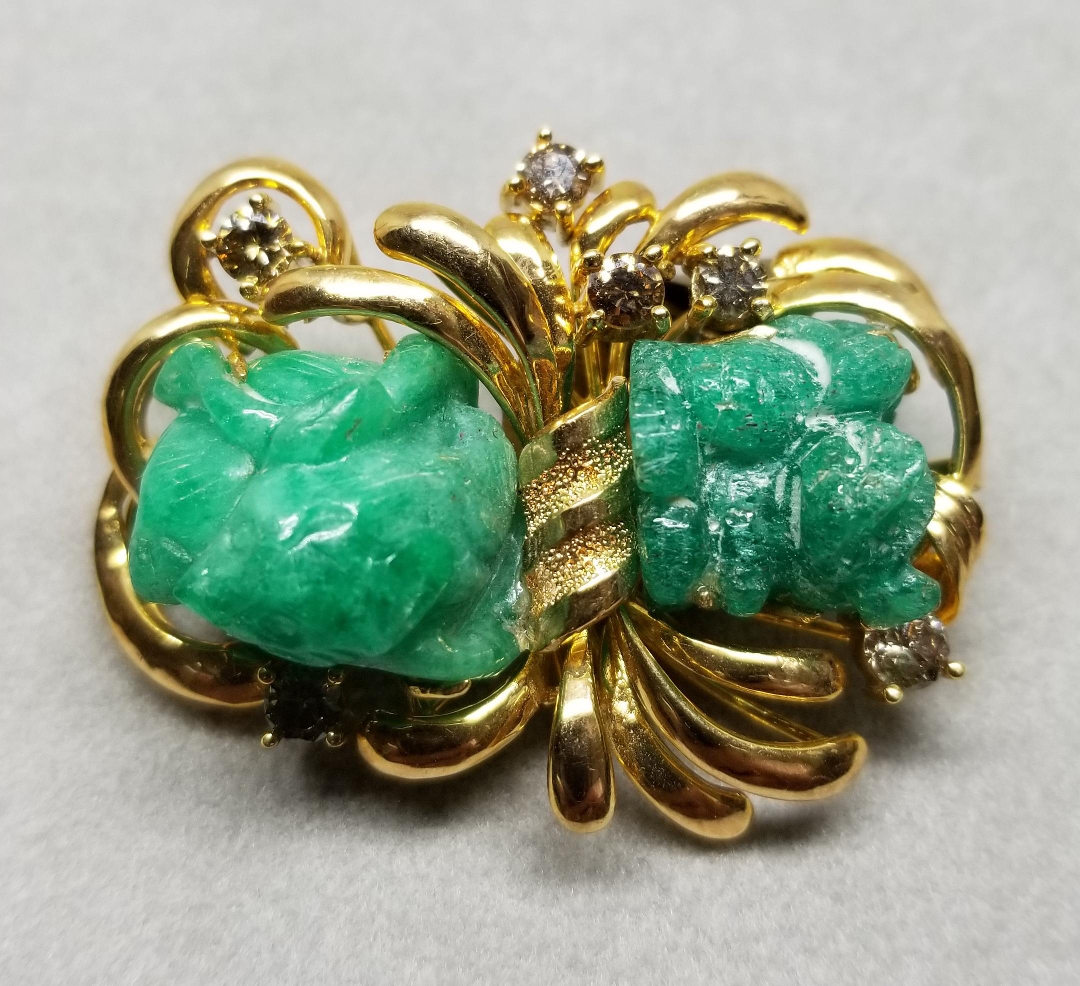 This piece of fine jewelry was designed and hand crafted by “Moshi” of New York, it was found in a vault from an estate sale and was never used.  14k yellow gold carved emerald and diamond pin, containing 2 hand carved emeralds weighing 30.82cts.