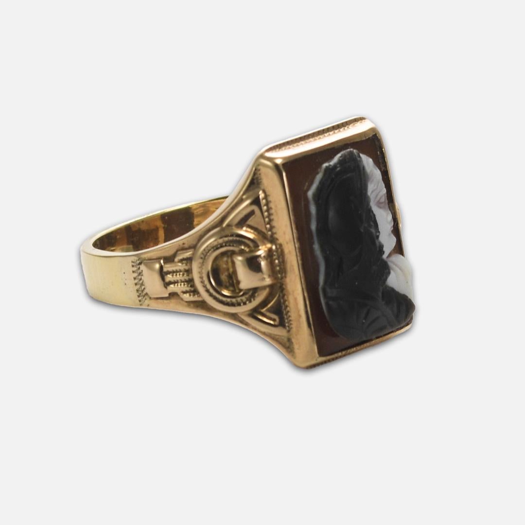 Men's signet ring with, man-made material, figurine.
The ring tests 14k, with an electronic tester, and weighs 6.9 grams. 
Ring size is 10.75  and can be sized, up or down, one full size or less for an extra fee. 
It is also in excellent condition,