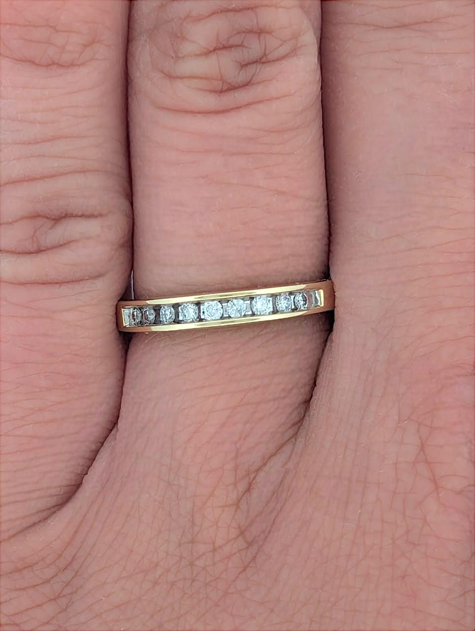 Crafted in 14K yellow gold, this elegant band features .25 CTW of natural round diamonds in a sleek channel setting. Designed for both beauty and durability, it’s perfect as a wedding band, anniversary ring, or a classic stacking piece to elevate