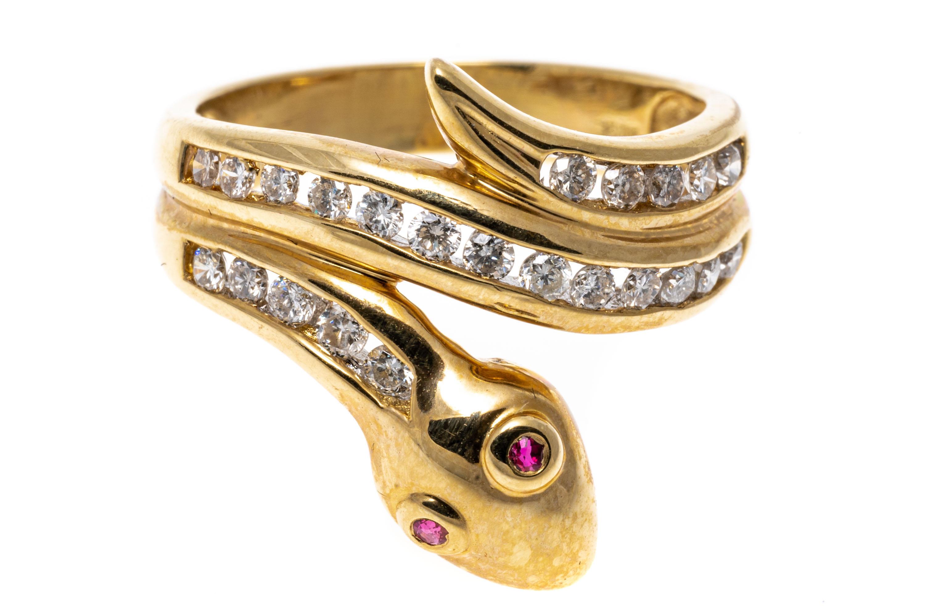 This charming ring is a coiled snake motif, with two red faceted, bezel set ruby eyes, approximately 0.02 TCW, and decorated with a channel set, round brilliant cut diamond body, approximately 0.40 TCW.
Marks: 14k
Dimensions: 3/4