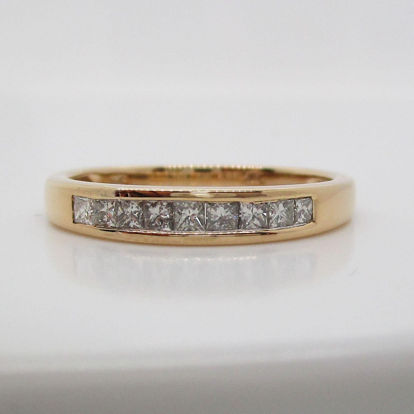 This is a beautiful contemporary wedding band in bright 14k yellow gold with a stunning array of channel set princess cut diamonds! The band is in mint condition! The warmth of the 14k yellow gold is the perfect backdrop for the brilliance of the
