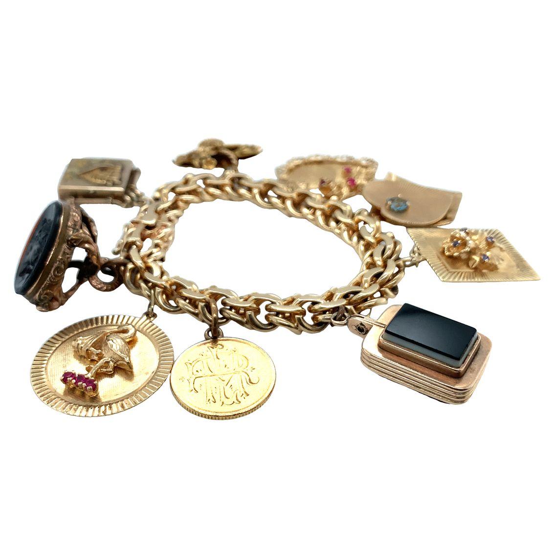 One 14K yellow gold charm bracelet with 9 miscellaneous charms and doubled circular links.

Nostalgic, substantial, weighty.

Metal: 14K yellow gold
Circa: 1960s
Size/Measurements: 7 inches long
Weight: 114 grams
