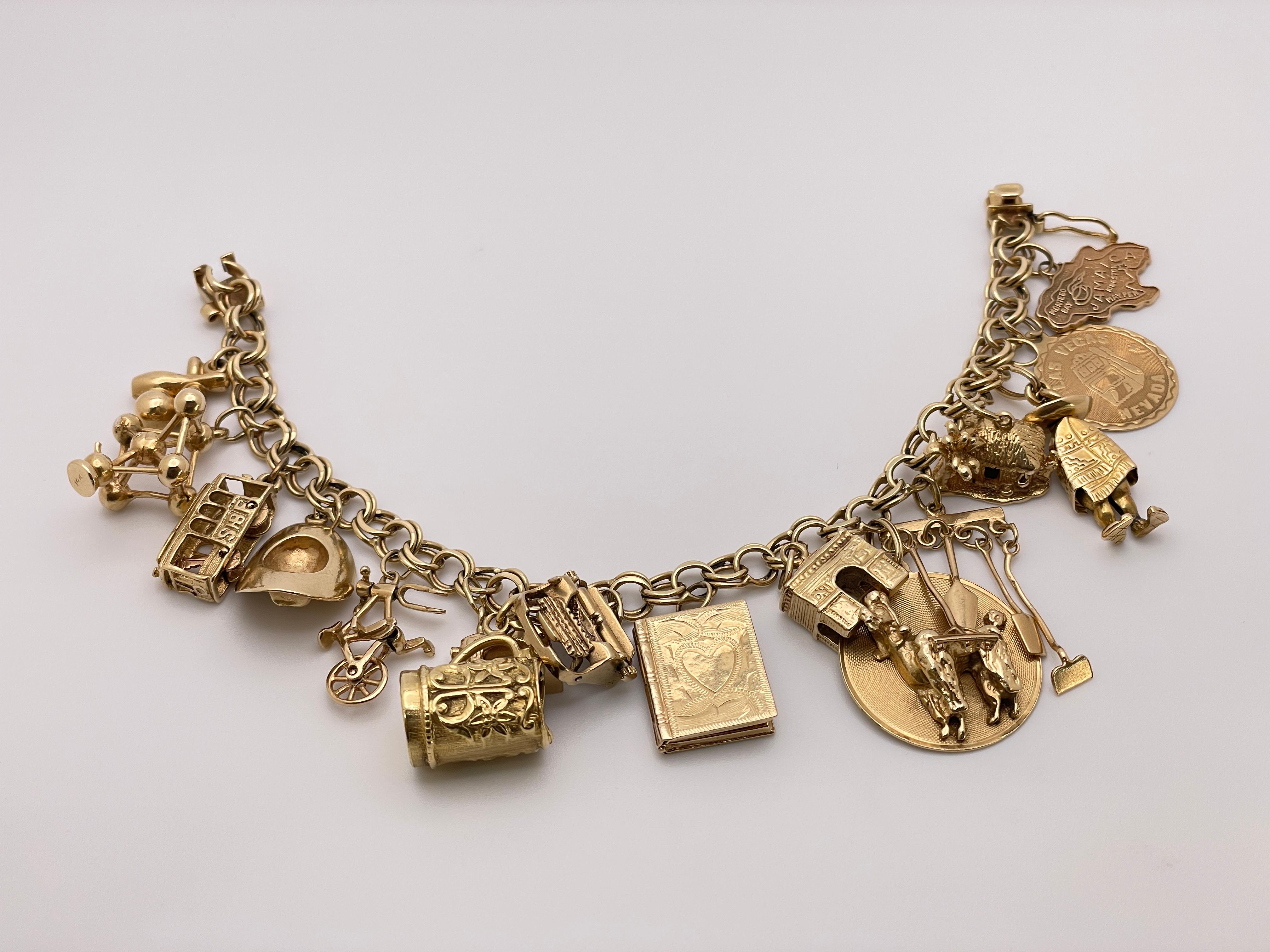 A unique 14K yellow gold charm bracelet featuring an array of 14K and one or two 10K yellow gold charms. Featuring many different intricately crafted gold charms portraying a book, a trolly bus, a dog, gardening tools, different structures, and