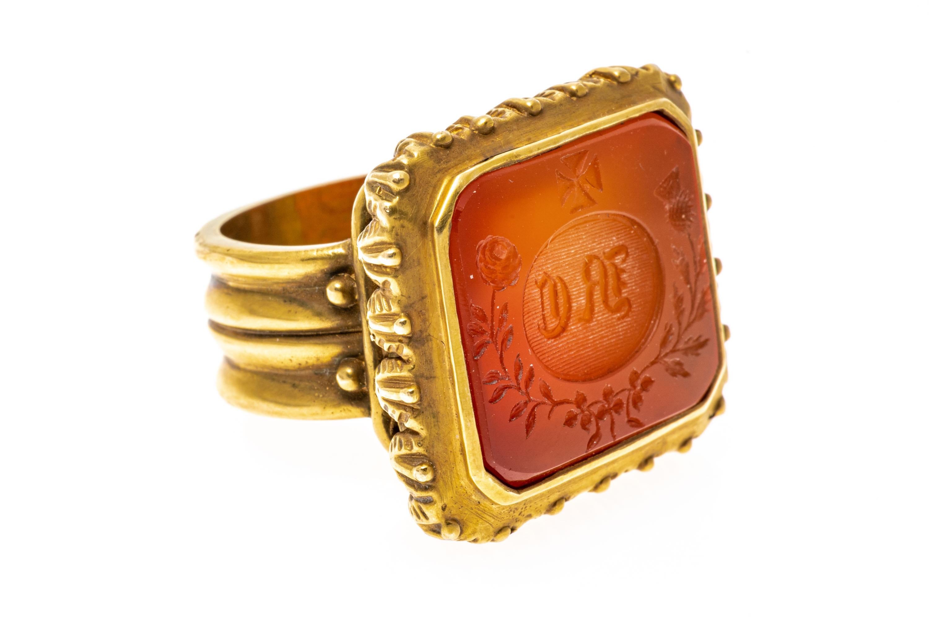14k yellow gold ring. This amazing chunky contemporary rectangular wax seal stamp ring features a carnelian intaglio, engraved with old English initials, a Maltese cross, a rose and a thistle. The ring is also adorned with a decorative foliate