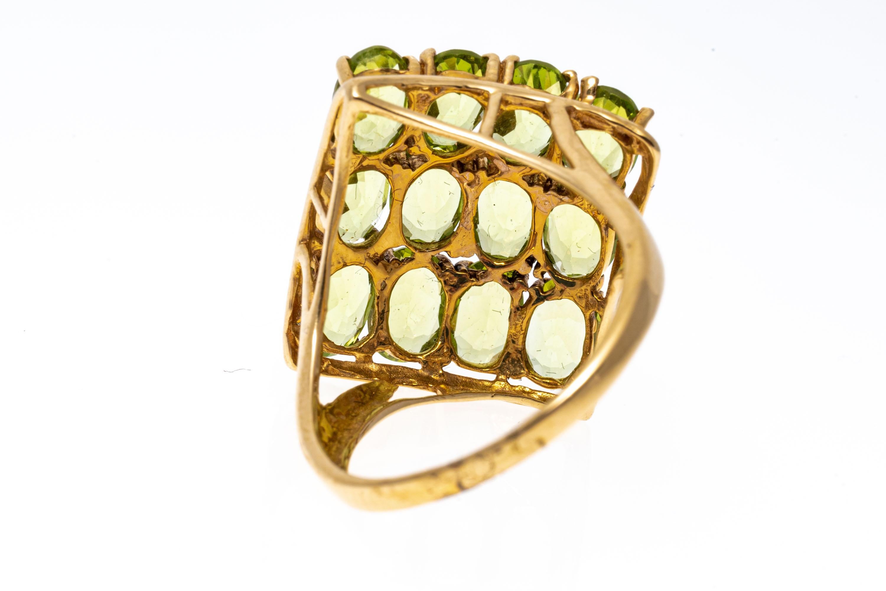 14k yellow gold ring. This unique ring is a peridot cluster, featuring a three row square, set on point, consisting of oval faceted, light chartreuse green color peridot stones, approximately 3.12 TCW and prong set. The ring also features wide,