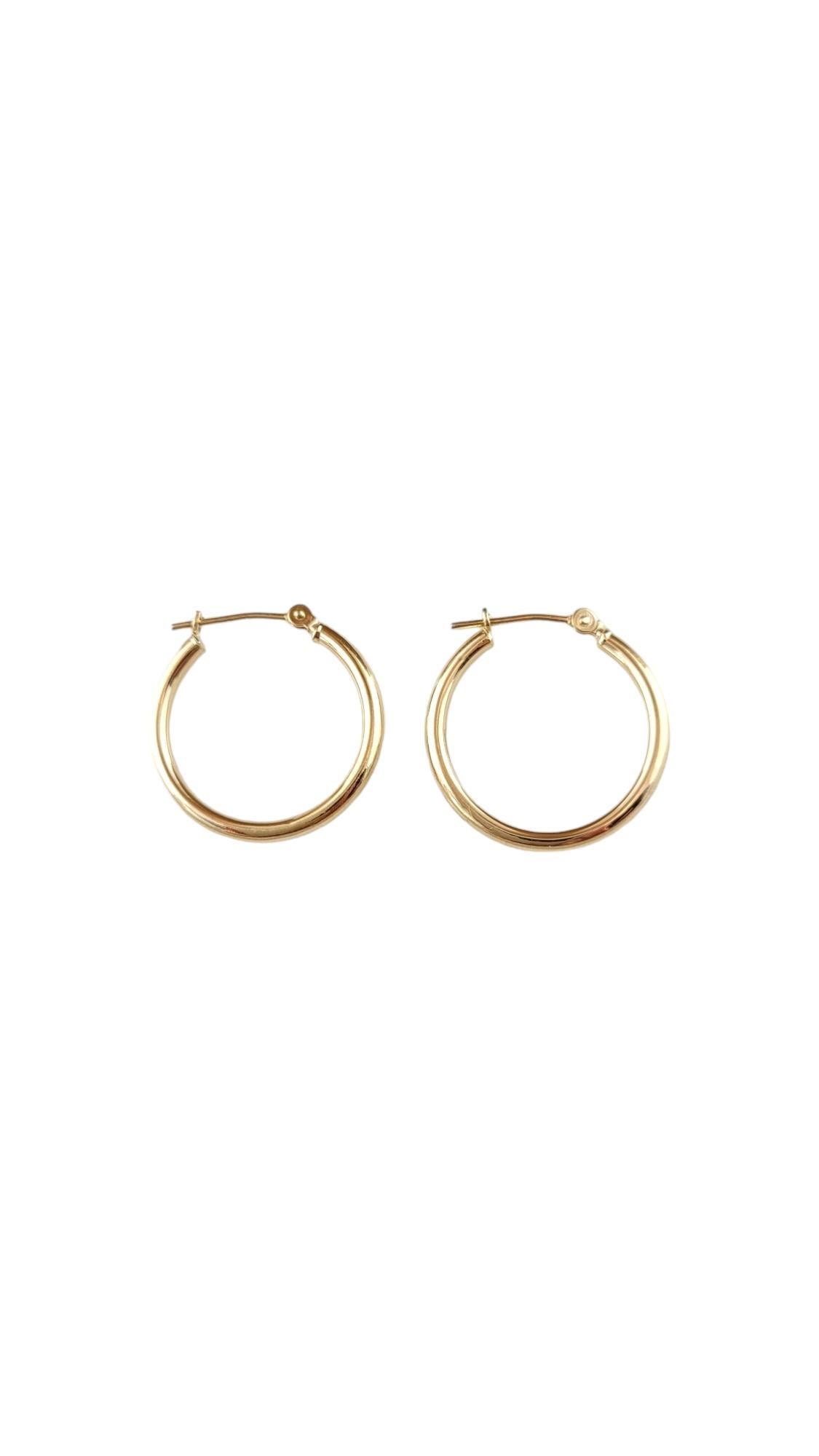Vintage 14 Karat Yellow Gold Hoop Earrings-

These classic gold hoops are a timeless addition to your collection. 

Size: 20.2 mm x 2.1 mm x 2.3 mm. 

Stamped: PC 14K Israel 

Weight: 0.5 dwt./ 0.9 gr.

Very good condition, professionally