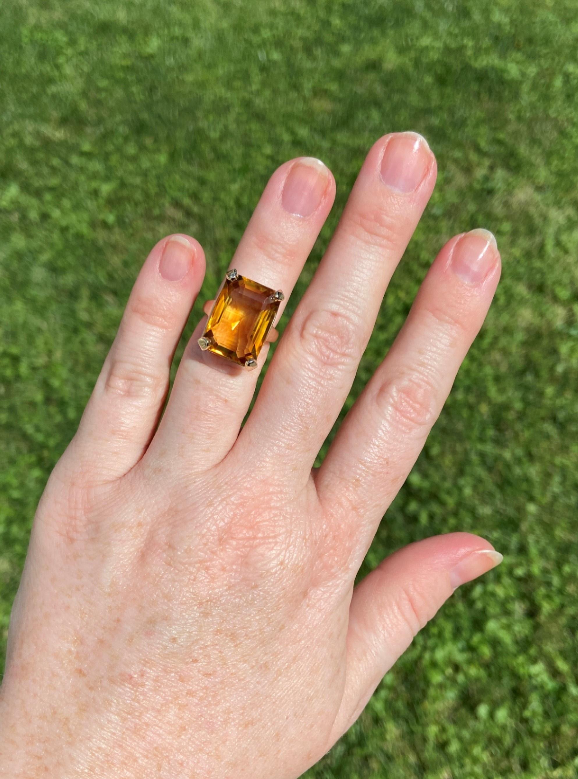 The centerpiece of this cocktail ring is a gorgeous golden honey colored emerald cut citrine. The clean lines of the citrine are enhanced by the simple geometry of the setting gallery, letting the citrine be the star of the show. If you stare into