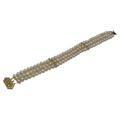 Bracelet à trois rangs de perles en or jaune 14 carats avec fermoir en perles