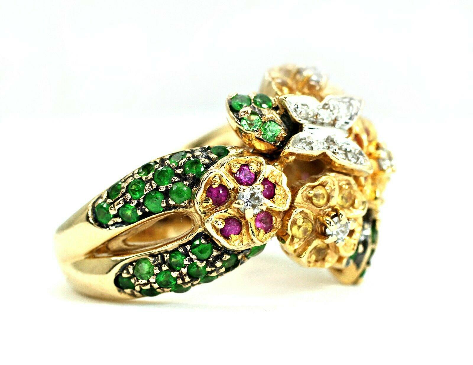 This is a 14k yellow gold cocktail ring with tsavorite, pink and yellow sapphire gemstones, and round diamonds. The tsavorite are 60 pieces, approximately 1.20 carat total weight. The pink and yellow sapphire are 30 pieces, approximately 0.60 carat