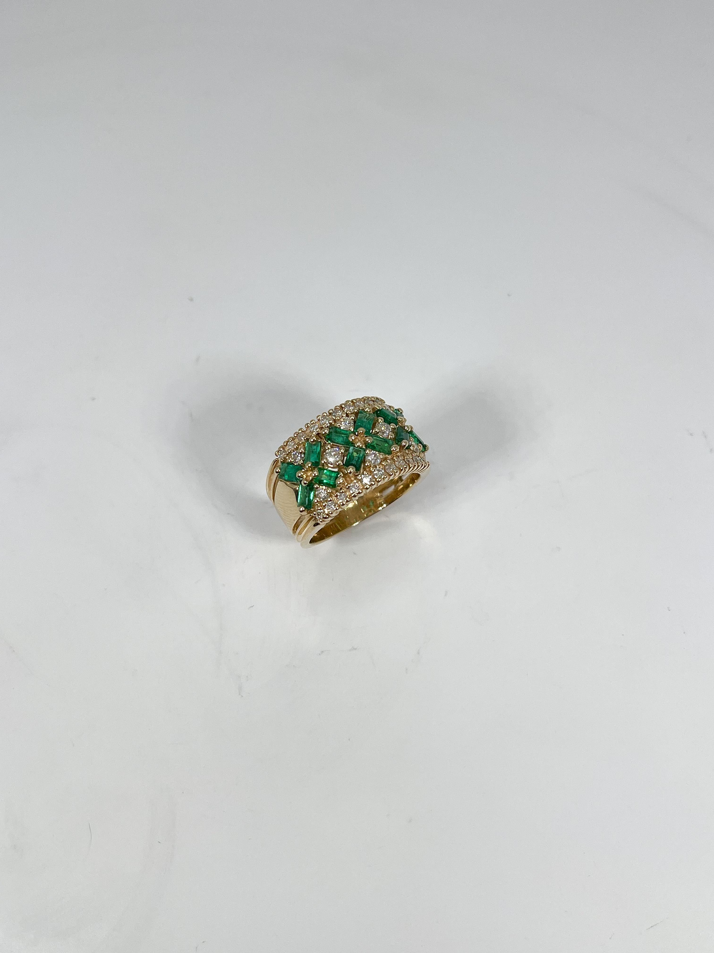 14k yellow gold contemporary emerald and diamond ring. The emeralds are baguettes, and the diamonds are round, the ring size is a 5 3/4, the width is 11.5 mm, and has a total weight of 6.84 grams. 