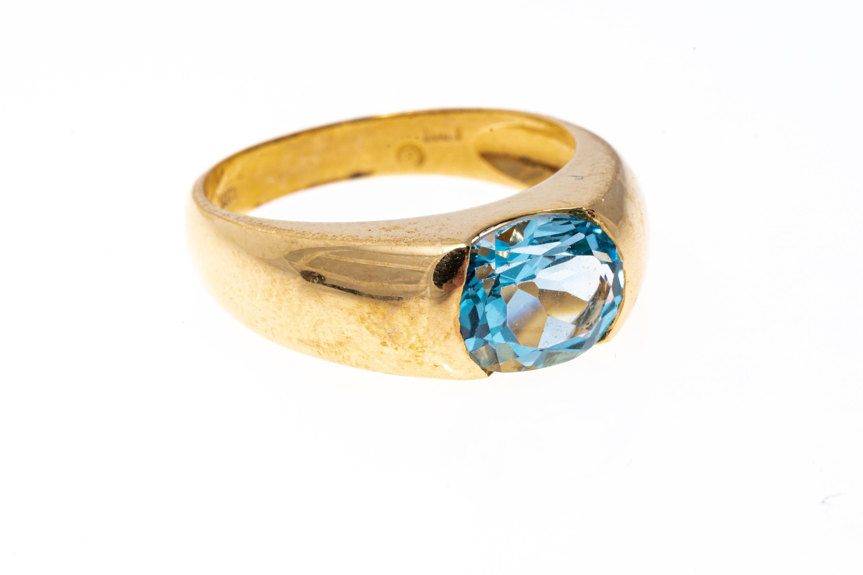 Bague contemporaine en or jaune 14 carats avec topaze bleue ovale horizontale en vente 1