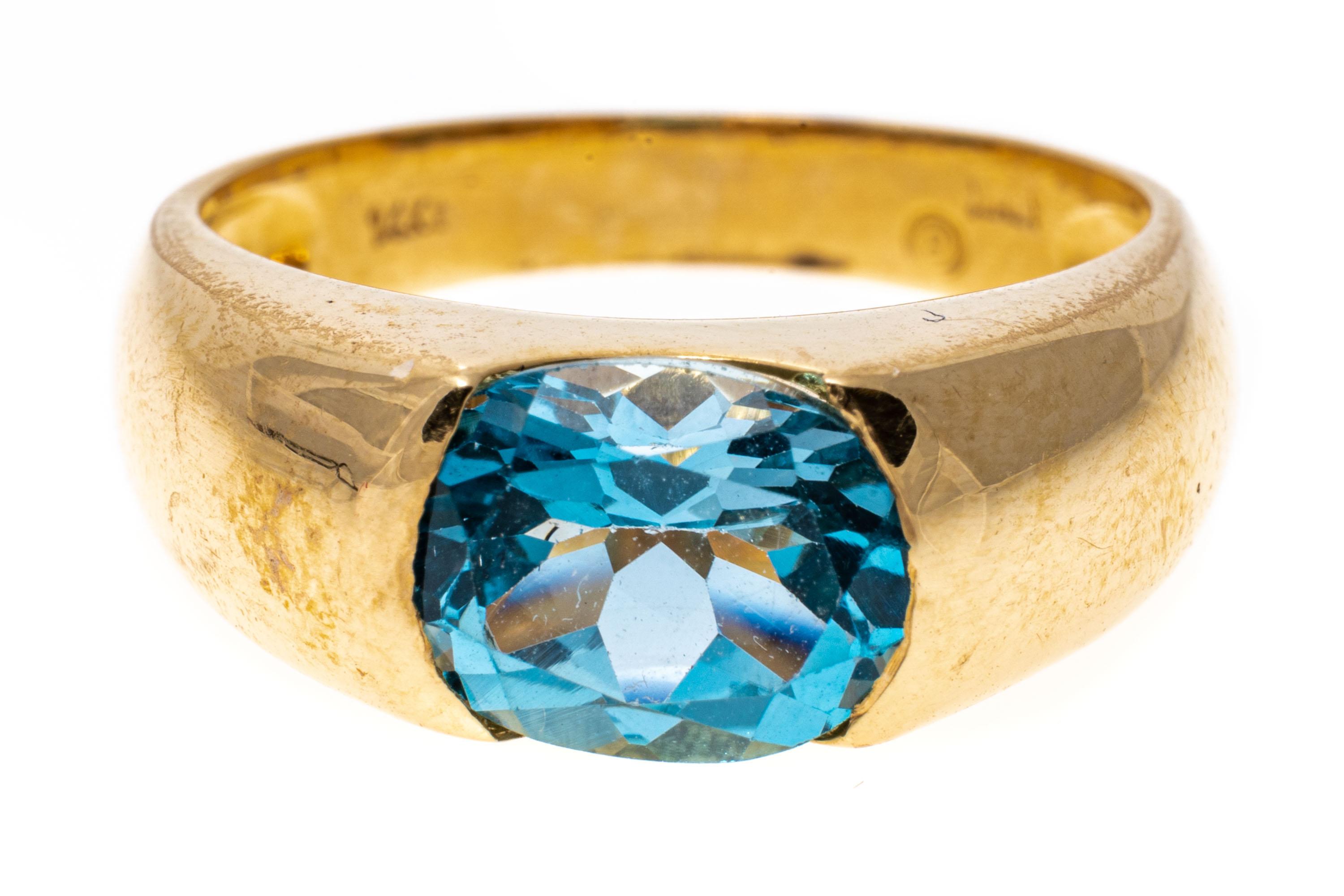 Women's 14k Yellow Gold Contemporary Horizontal Oval Blue Topaz Ring For Sale