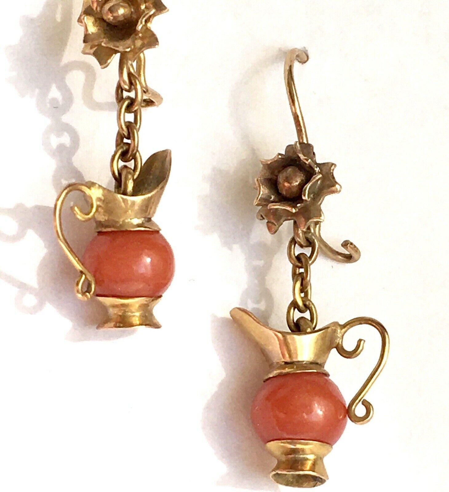 14K Yellow Gold Coral Dangling Art Deco Earrings

Length:  1 inch 
Hallmarks: None
Gold Content: 14 Karat
Gems: Italian Coral, 5.7 mm Mediterranean Coral bead  
Design: Possibly Etruscan Revival circa 1880, surely an Art Deco 1930s 
Country of Make: