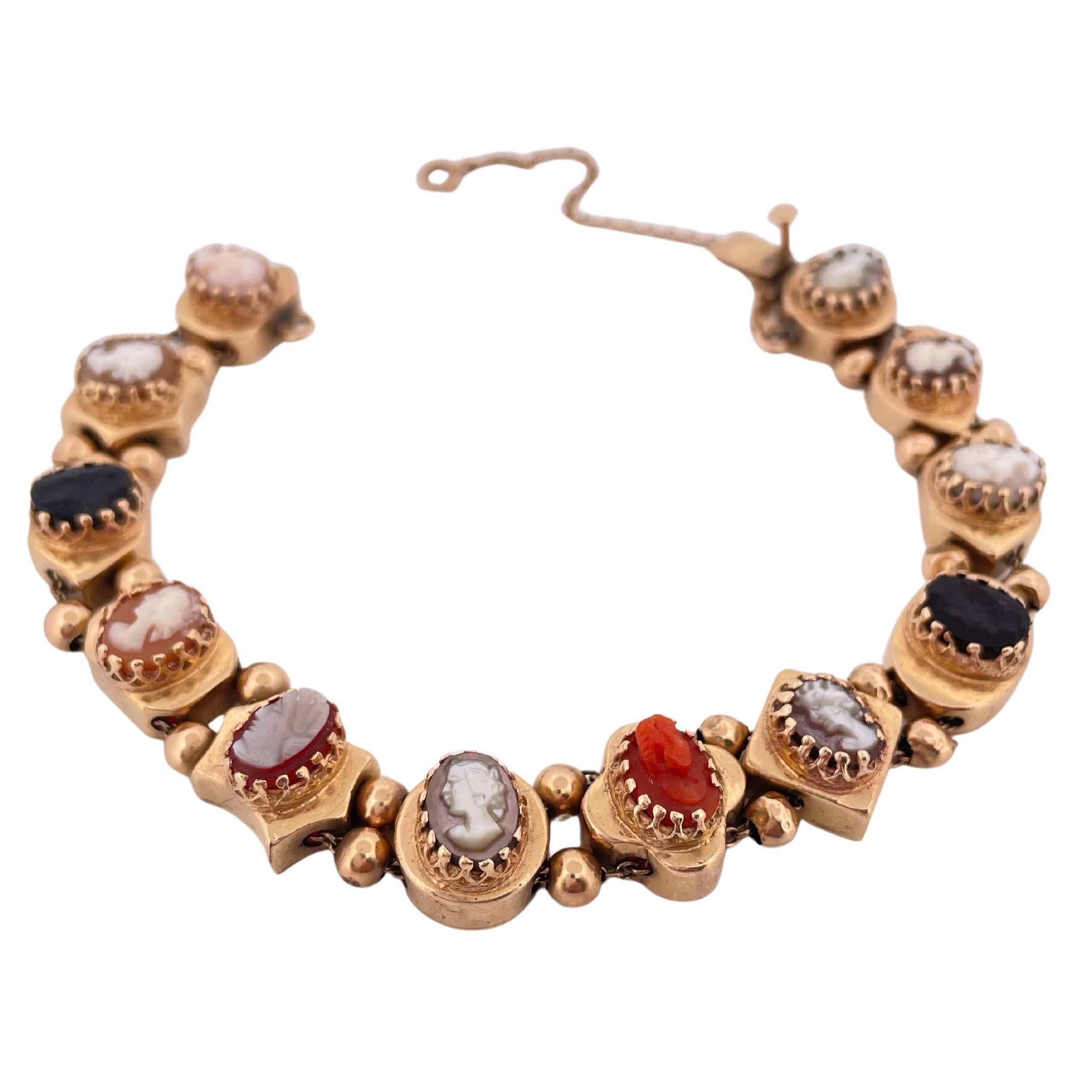 Crafted in rich 14k yellow gold, this vintage slide bracelet showcases a charming collection of intricately carved cameos set in alternating bezel frames. Each slide features a distinct hand-carved portrait in onyx, coral, and shell, offering a