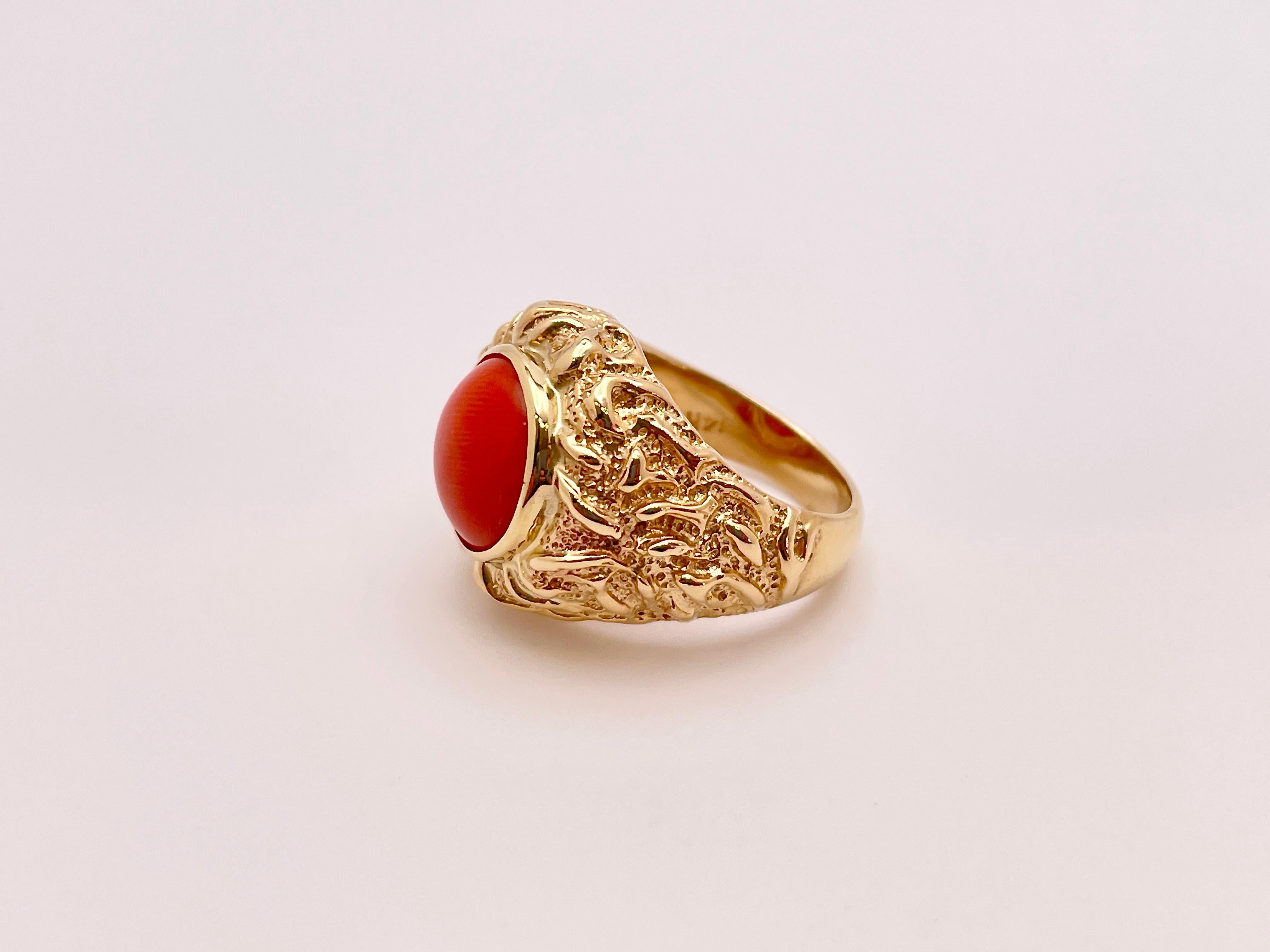 An original 14K handmade coral ring. Centered with one round double-sided cabochon natural orange color coral weighing 8-10 CT, measuring approximately 12.50 mm in diameter and 7.20 mm in depth.

Gross Weight: 13.70 Grams
Ring Size: 7.25 US (Sizable)