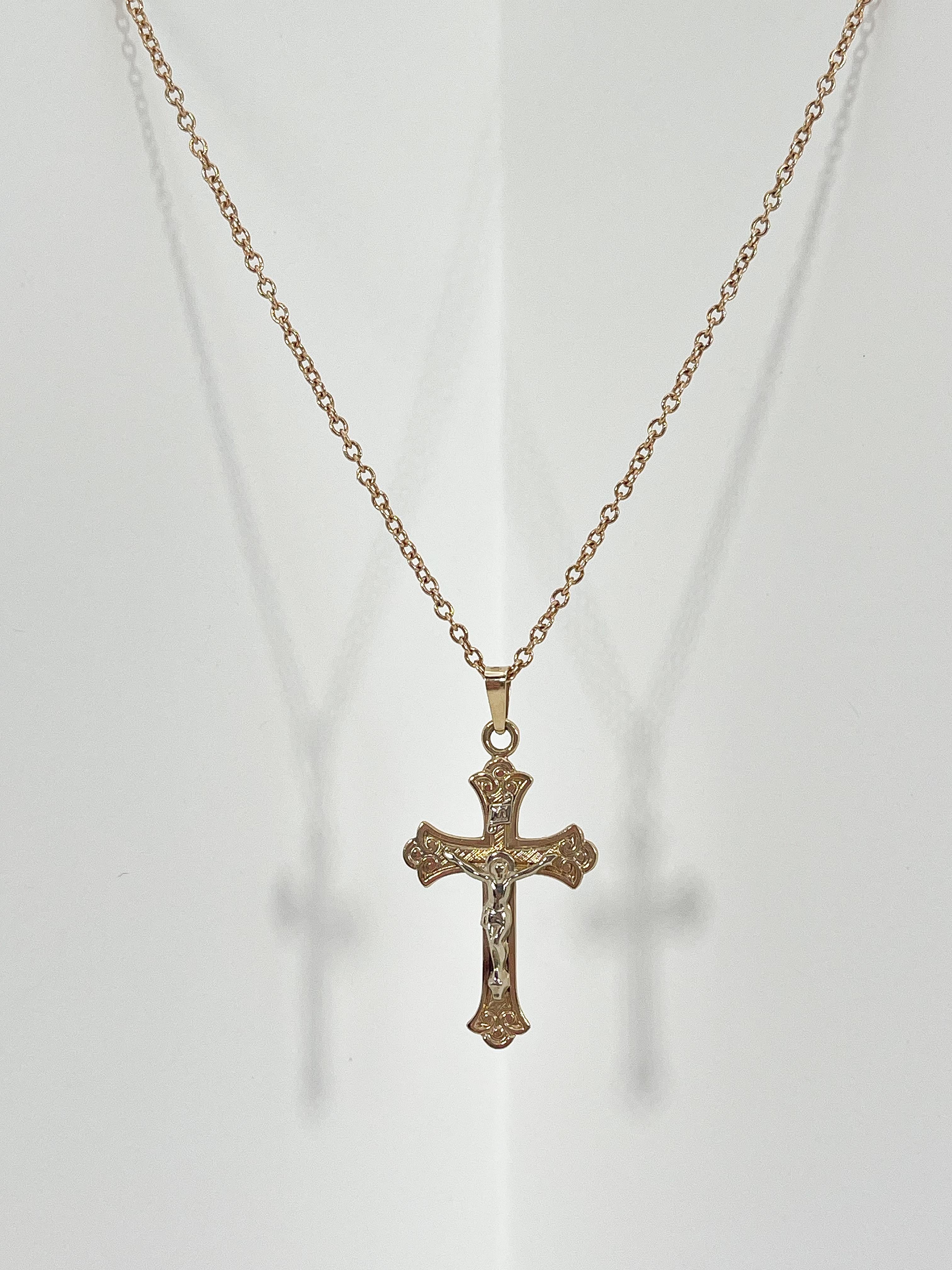 14k yellow gold crucifix pendant necklace. Pendant measures to be 25.5mm x 17.5mm, comes on a 14.5 inch diamond cut cable chain, has a spring ring to open and close necklace, and necklace has a total weight of 3.6 grams.