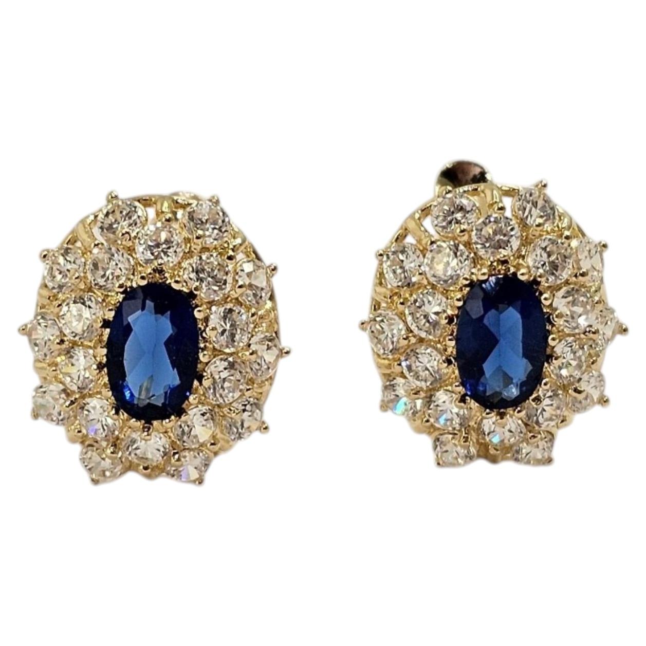 Orecchini a halo ovali in oro giallo 14 carati con zirconi blu #25759