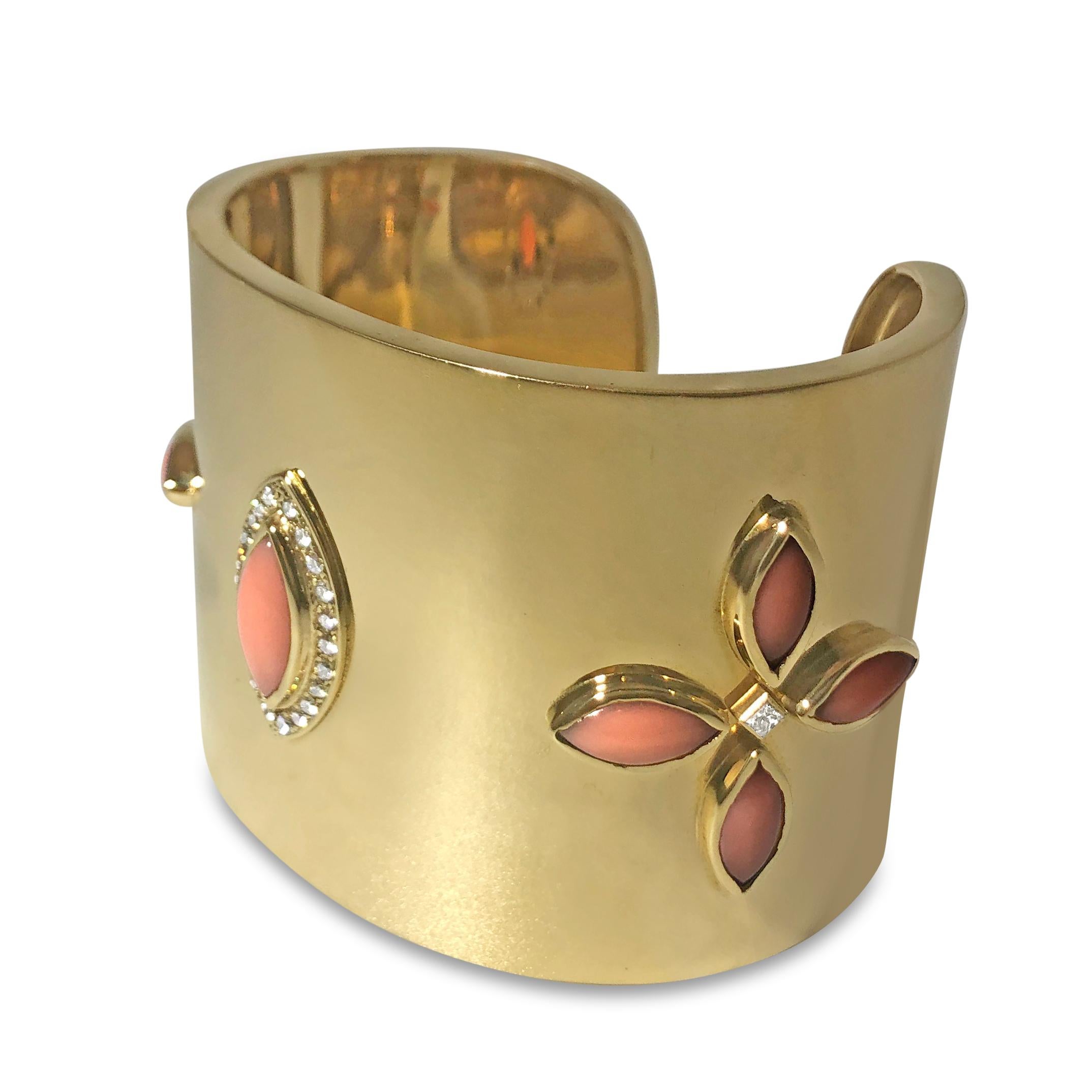 Our statement cuff will wow you and everyone else who sees it! This slip-on 2 inch cuff bracelet features high shine 14K yellow gold with 24 round 1.6mm and 2.4mm white diamonds, totaling 0.60ct, and 9 pristine coral cabochons.

Specifications:
-